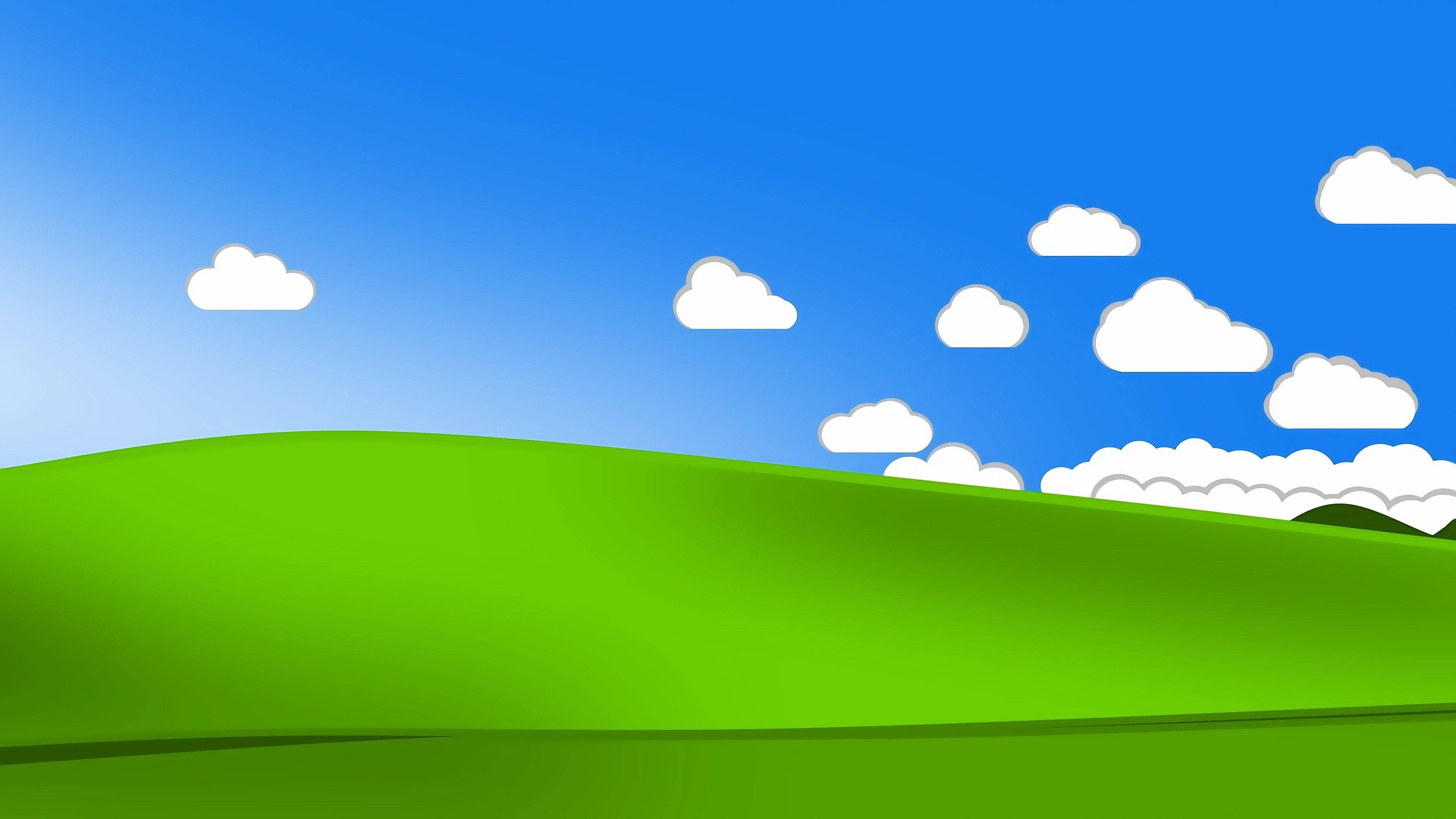 Windows 桌布 壁紙 — 充滿活力的綠色起伏山丘在晴朗的藍天下延伸，點綴著蓬鬆的白雲。