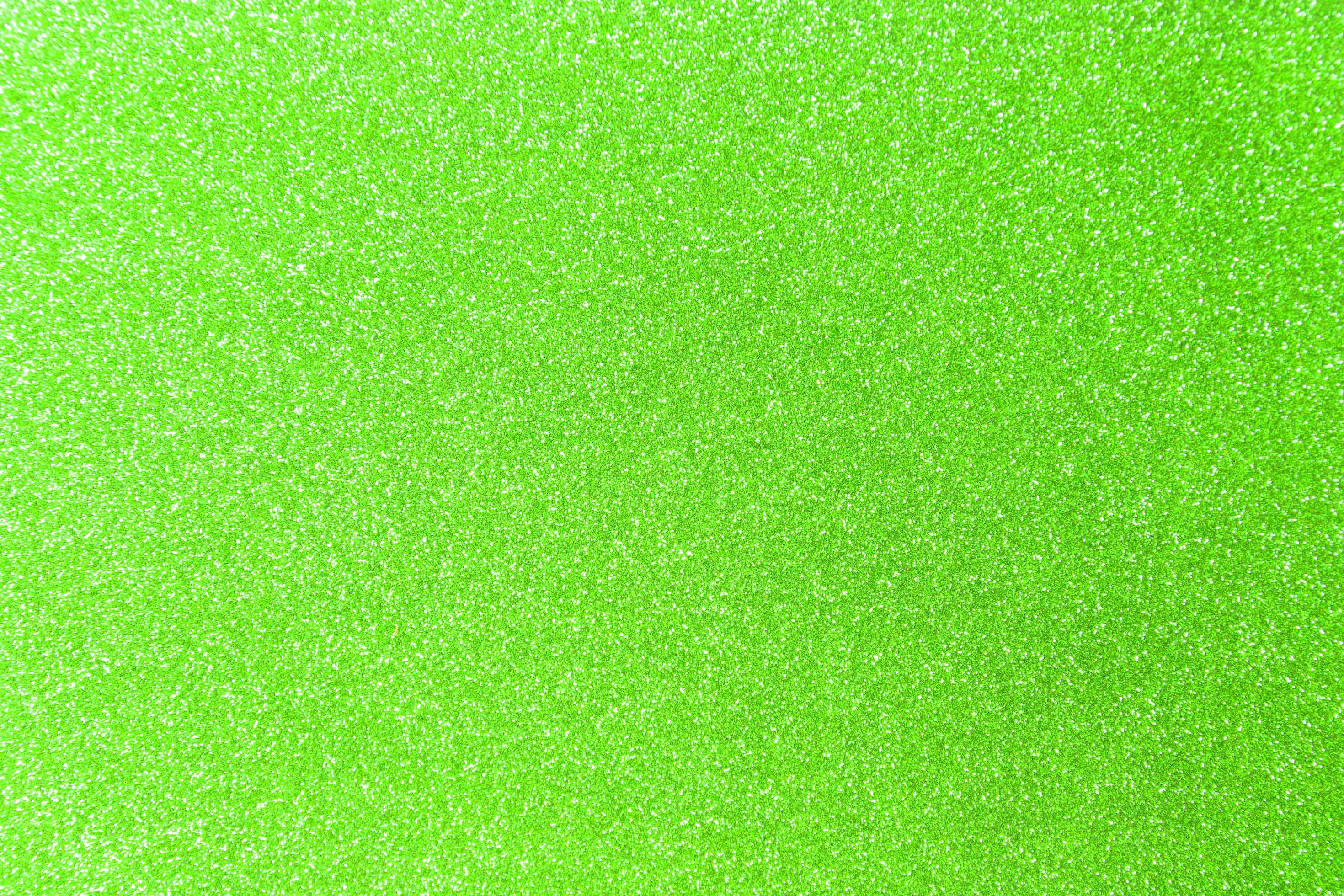 Green Glitter 桌布 壁紙 — 充滿活力的萊姆綠色亮粉紋理，帶有閃閃發光的白色斑點覆蓋整個表面。