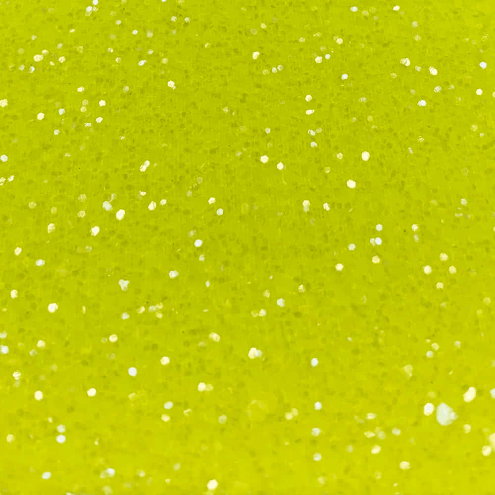 Yellow Glitter 桌布 壁紙 — 充滿活力的萊姆綠色表面，在明亮光線下散佈著白色亮粉顆粒。