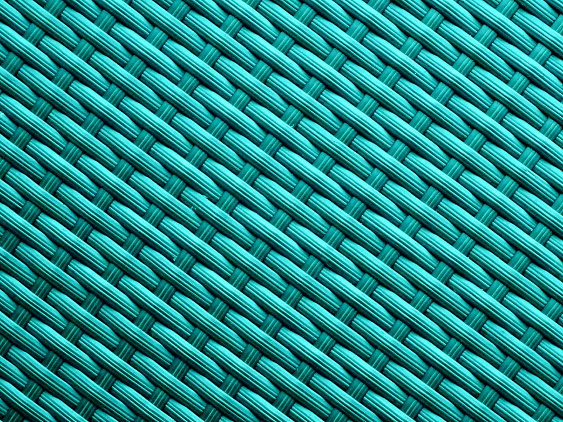 Turquoise Blue 桌布 壁紙 — 充滿活力的藍綠色編織合成纖維特寫，形成緊密的對角線圖案，帶有微妙的陰影。