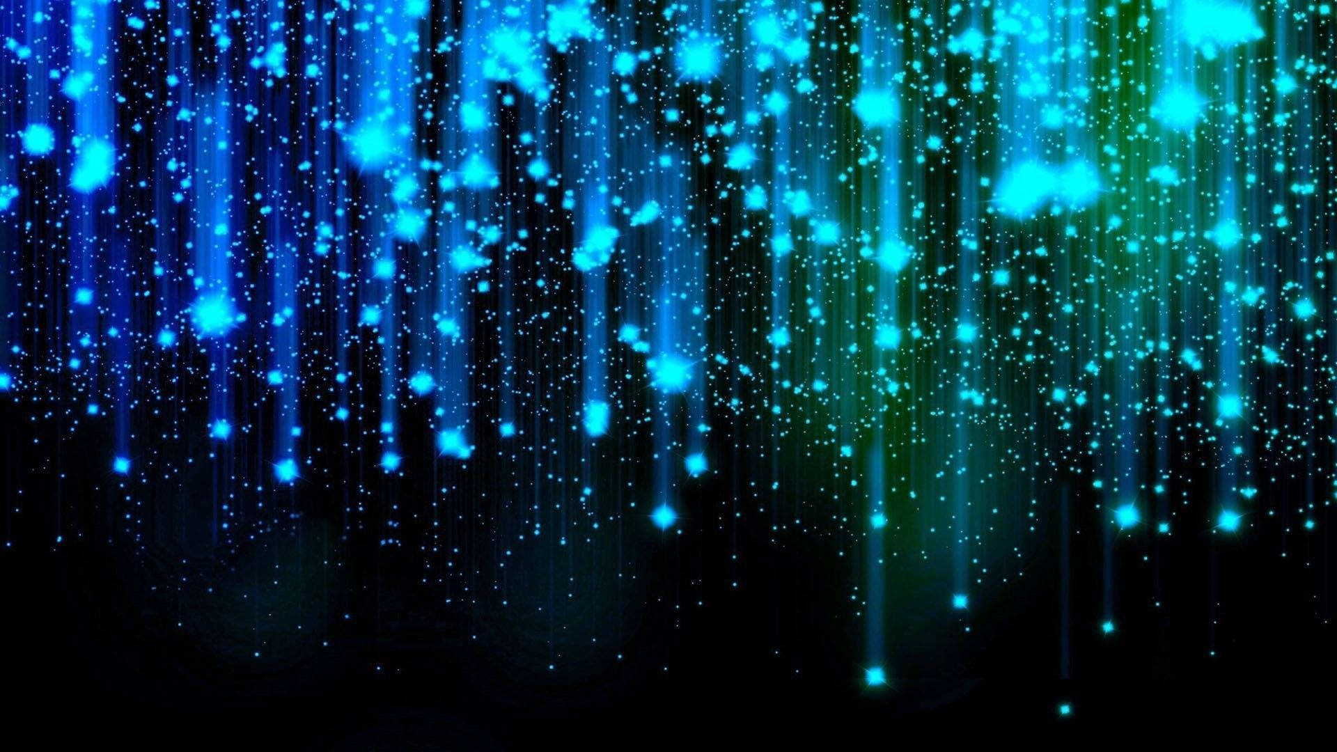 Amazing 桌布 壁紙 — 充滿活力的藍色和綠色發光粒子像數位雨一樣在深黑色背景上傾瀉而下。