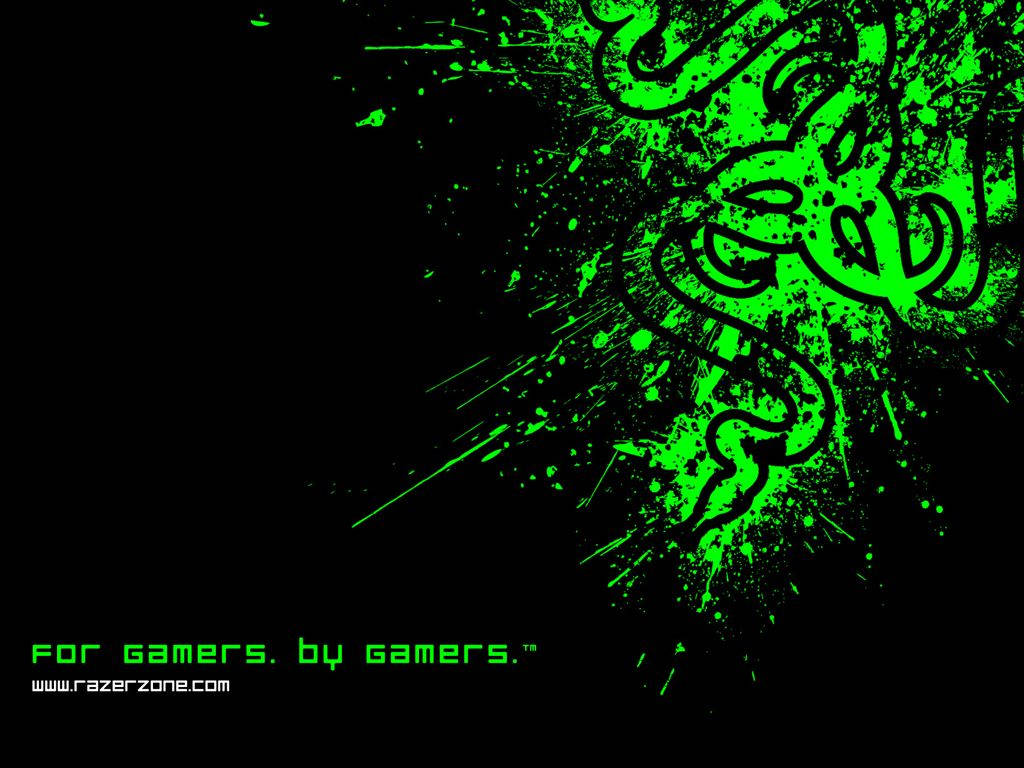 雷蛇 桌布 壁紙 — 充滿活力的螢光綠色 Razer 標誌在純黑色背景上動態爆發，帶有飛濺效果和遊戲口號。