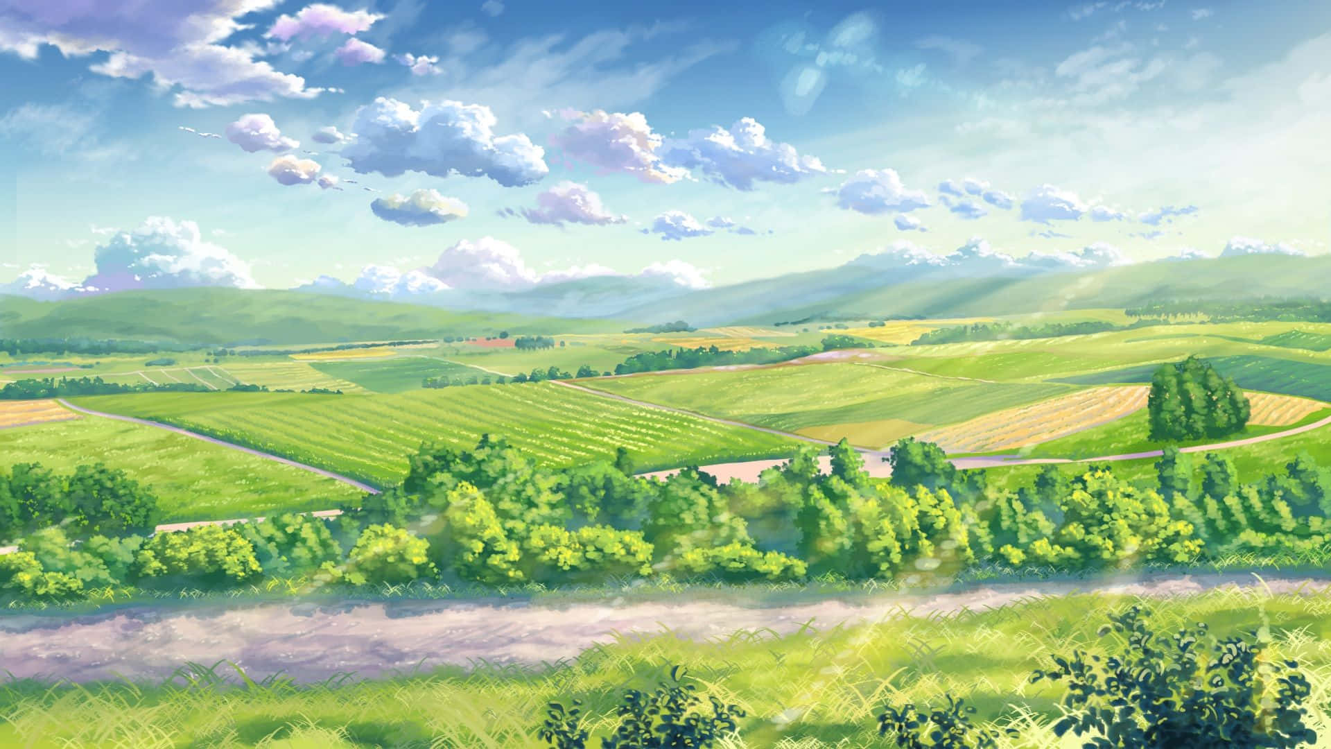 動畫風景 桌布 壁紙 — 充滿活力的起伏綠色山丘，在明亮的藍天下，有蓬鬆的雲朵和蜿蜒的道路穿過茂密的鄉村。