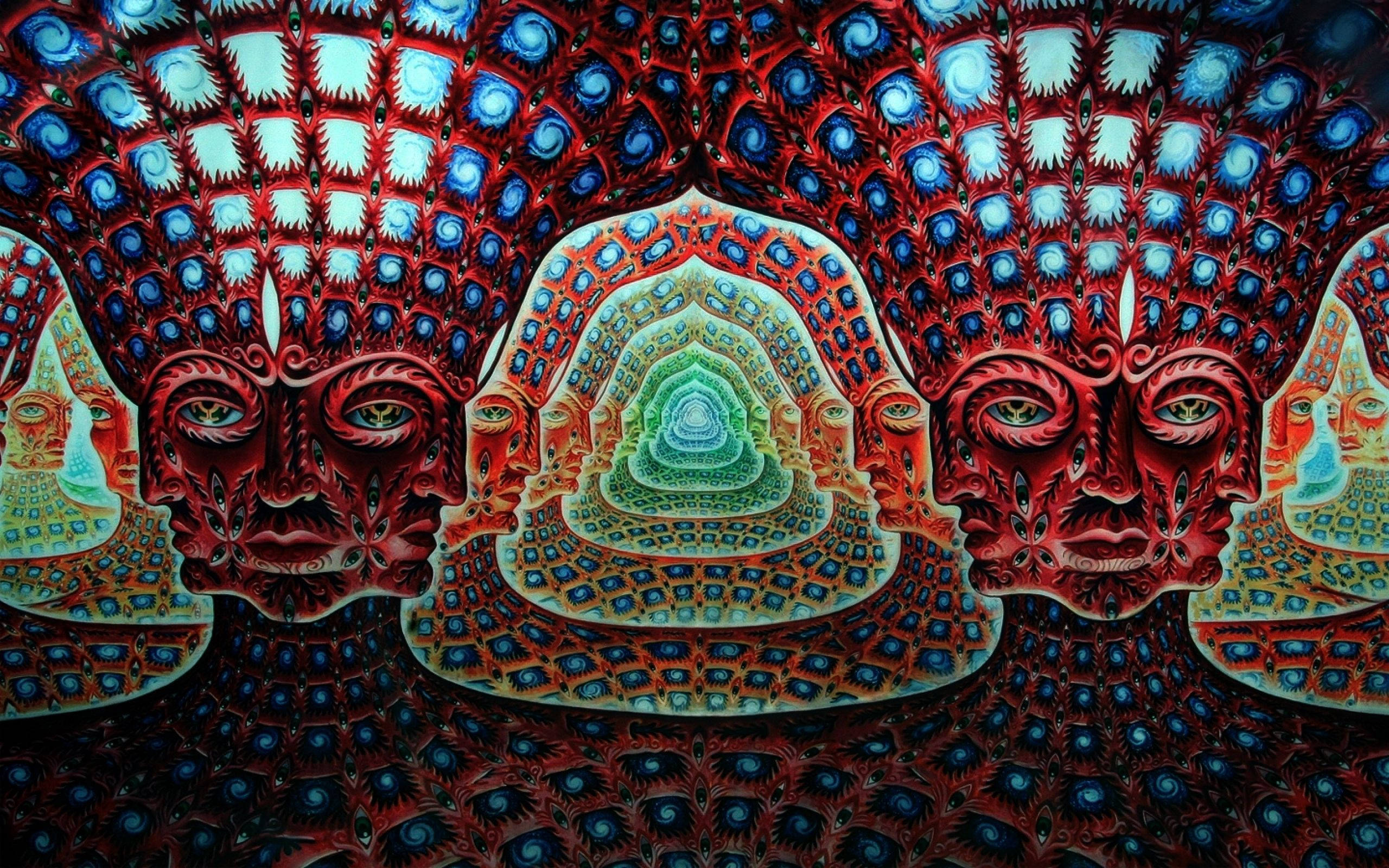 工具 桌布 壁紙 — 充滿活力的超現實面孔，帶有複雜的紅、藍、綠色圖案，從中央螺旋曼陀羅向外輻射。