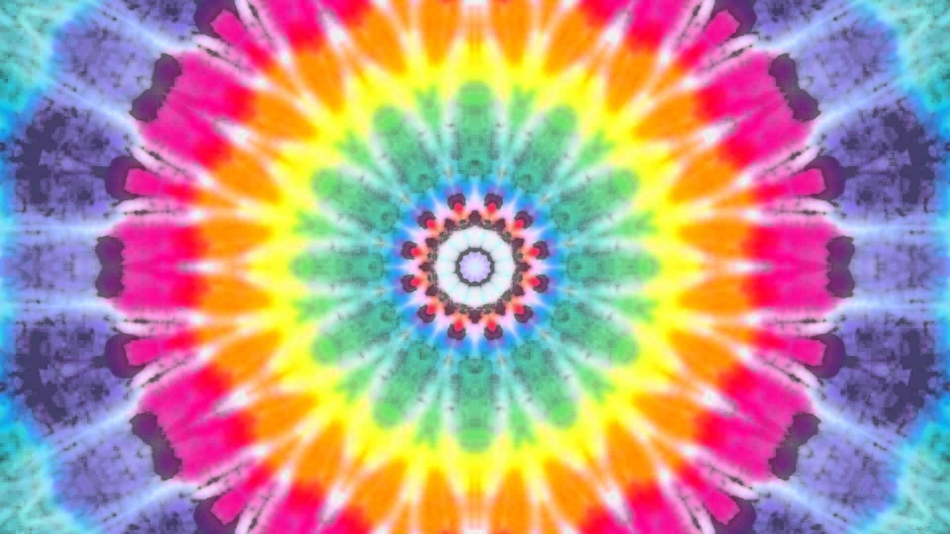 扎染 桌布 壁紙 — 充滿活力的迷幻紮染曼陀羅從中央白色核心散發出粉紅色、橙色、黃色、綠色和藍色的對稱爆發。