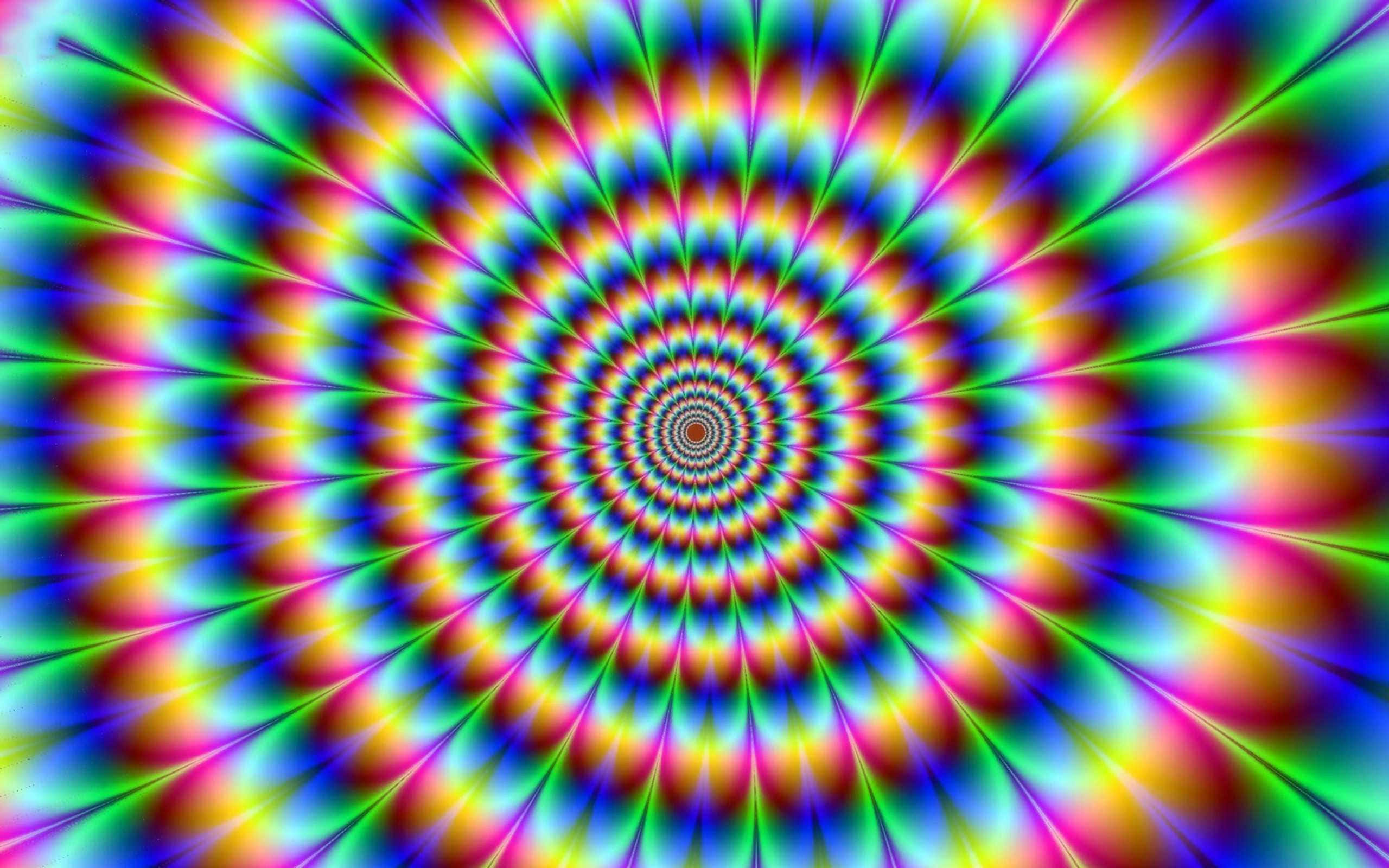 Illusion 桌布 壁紙 — 充滿活力的迷幻螺旋以彩虹色向外輻射，營造出催眠隧道效果。