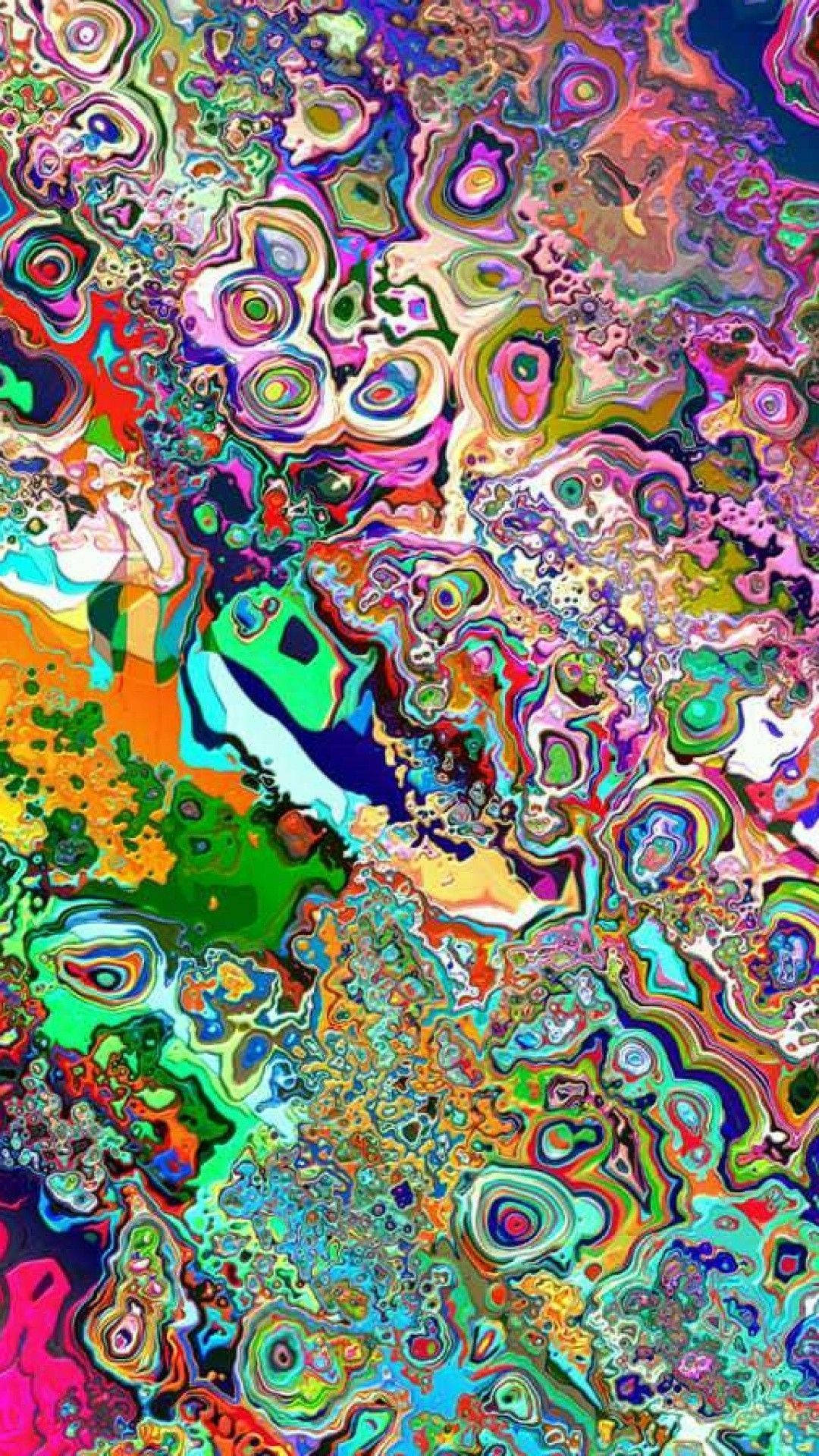 一幅萬花筒般的數位藝術作品，帶有旋轉的霓虹色彩和有機圖案。 — 迷幻動圖 壁紙