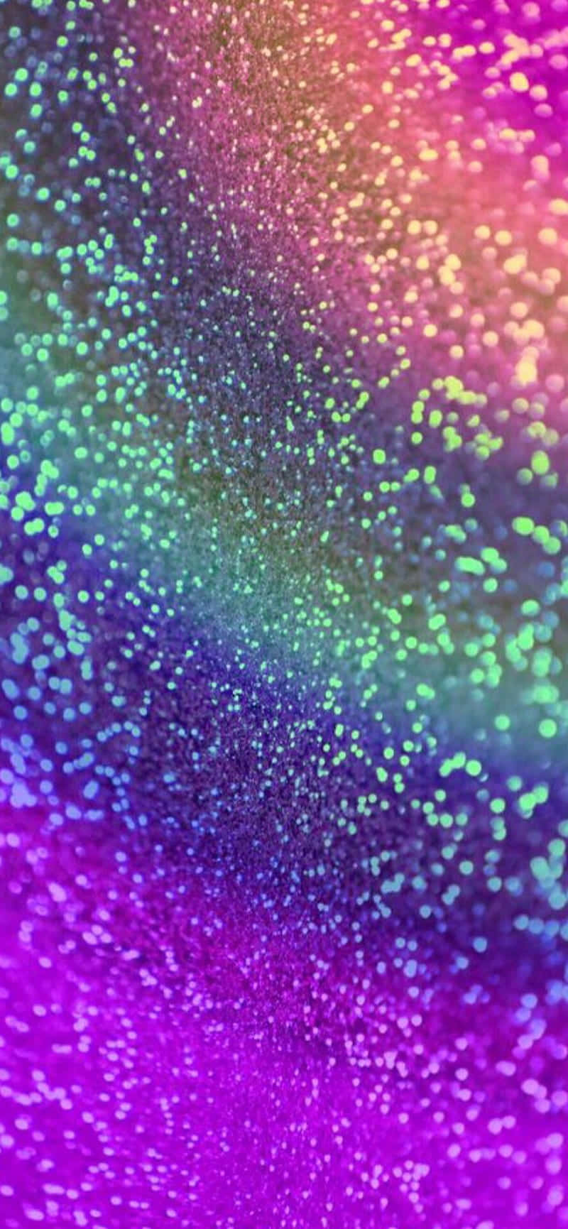 Rainbow Glitter 桌布 壁紙 — 充滿活力的閃粉粒子在深色背景上以紫色到粉紅色到藍綠色的彩虹漸變旋轉。
