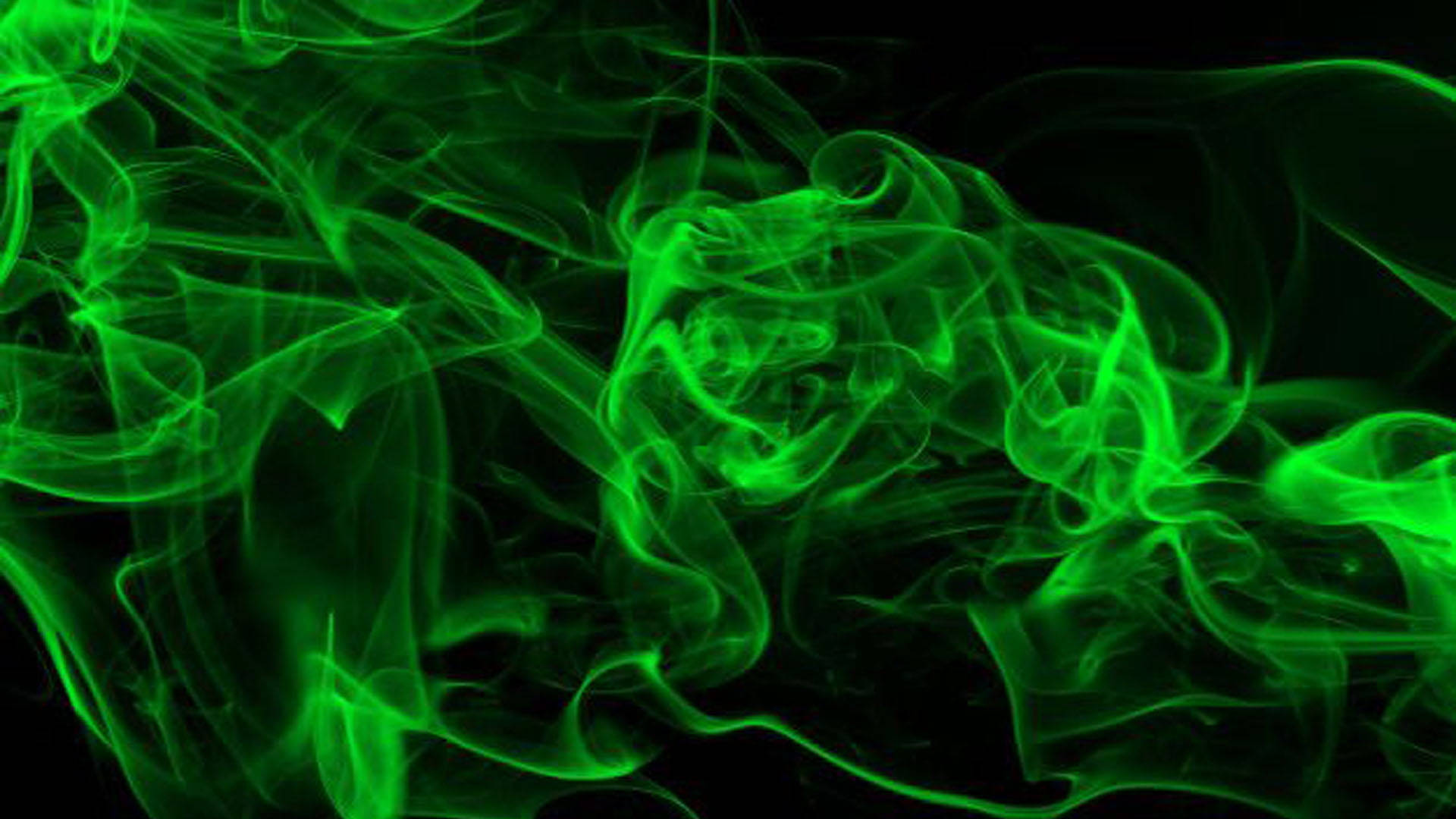 Green Abstract 桌布 壁紙 — 充滿活力的霓虹綠色煙霧在純黑色背景上動態旋轉，營造出空靈而神秘的氛圍。