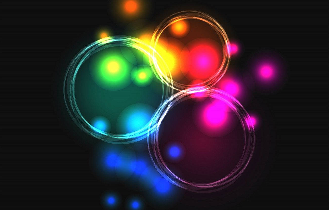 Neon Light 桌布 壁紙 — 充滿活力的霓虹色調發光圓圈在黑暗背景上漂浮，創造出動態的抽象燈光秀。
