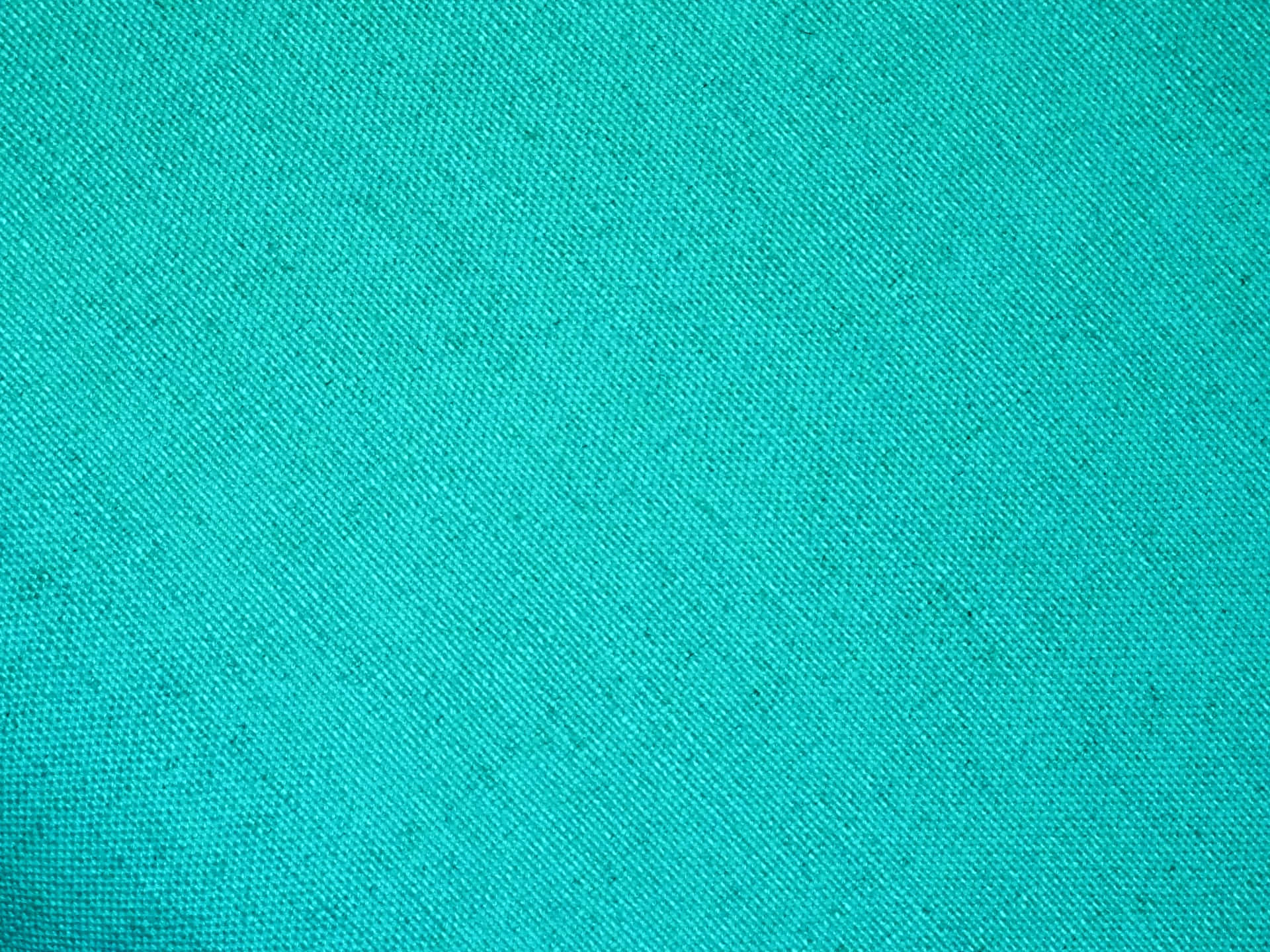 Turquoise Blue 桌布 壁紙 — 充滿活力的青綠色布料特寫，可見編織紋理和細微的自然瑕疵。