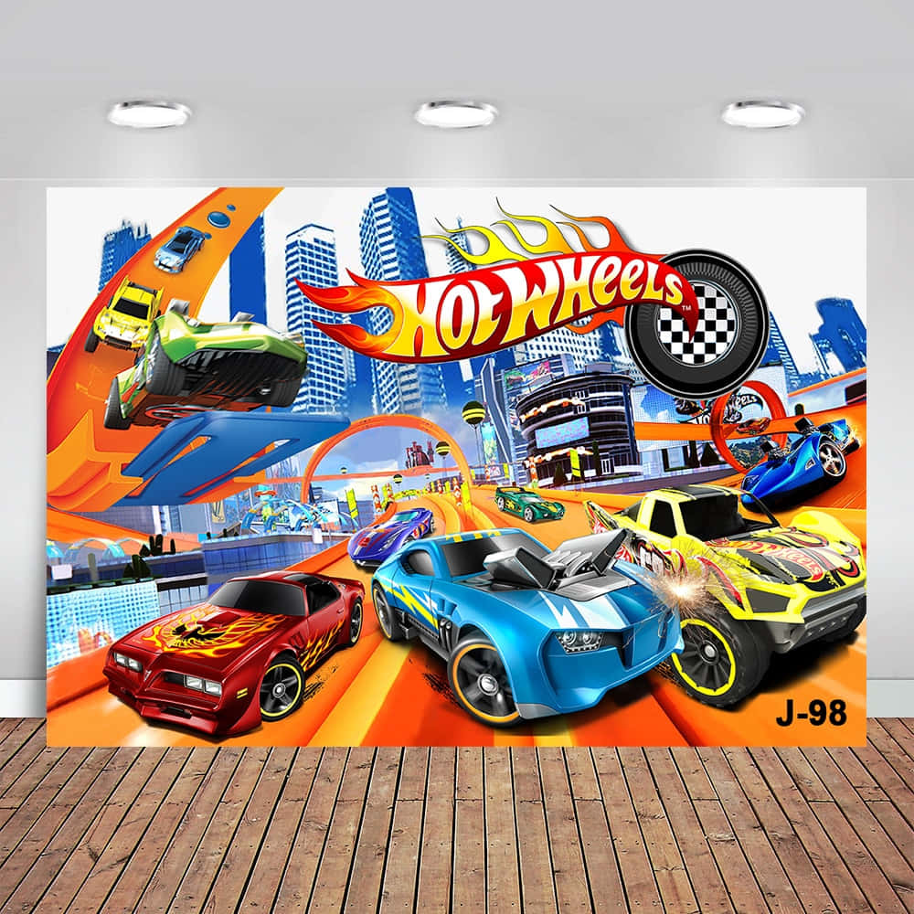 toys 桌布 壁紙 — 充滿活力的風火輪賽車在明亮的日光下，在火熱的橙色賽道上穿梭於未來城市景觀中。