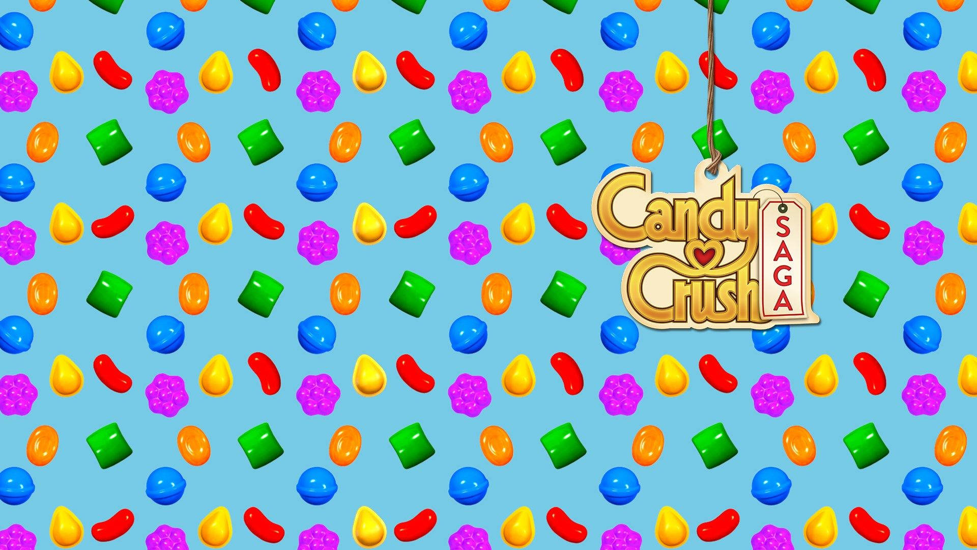 糖果 桌布 壁紙 — 充滿色彩繽紛糖果的鮮豔藍色背景，掛著一個「Candy Crush Saga」標籤。