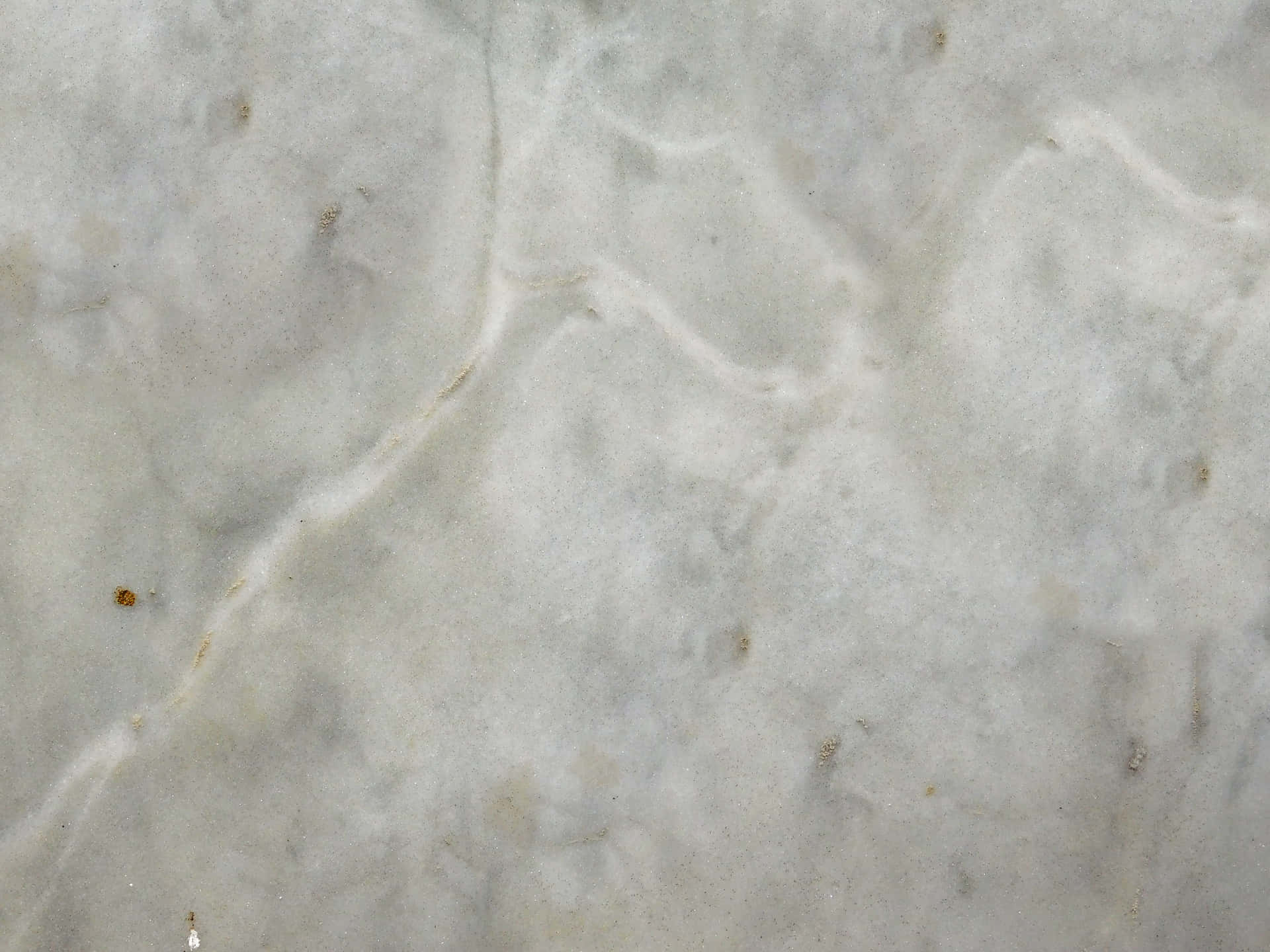 Stone texture 壁紙 — 光滑白色大理石表面的特寫，帶有細微的灰色紋理和微弱的金色斑點。