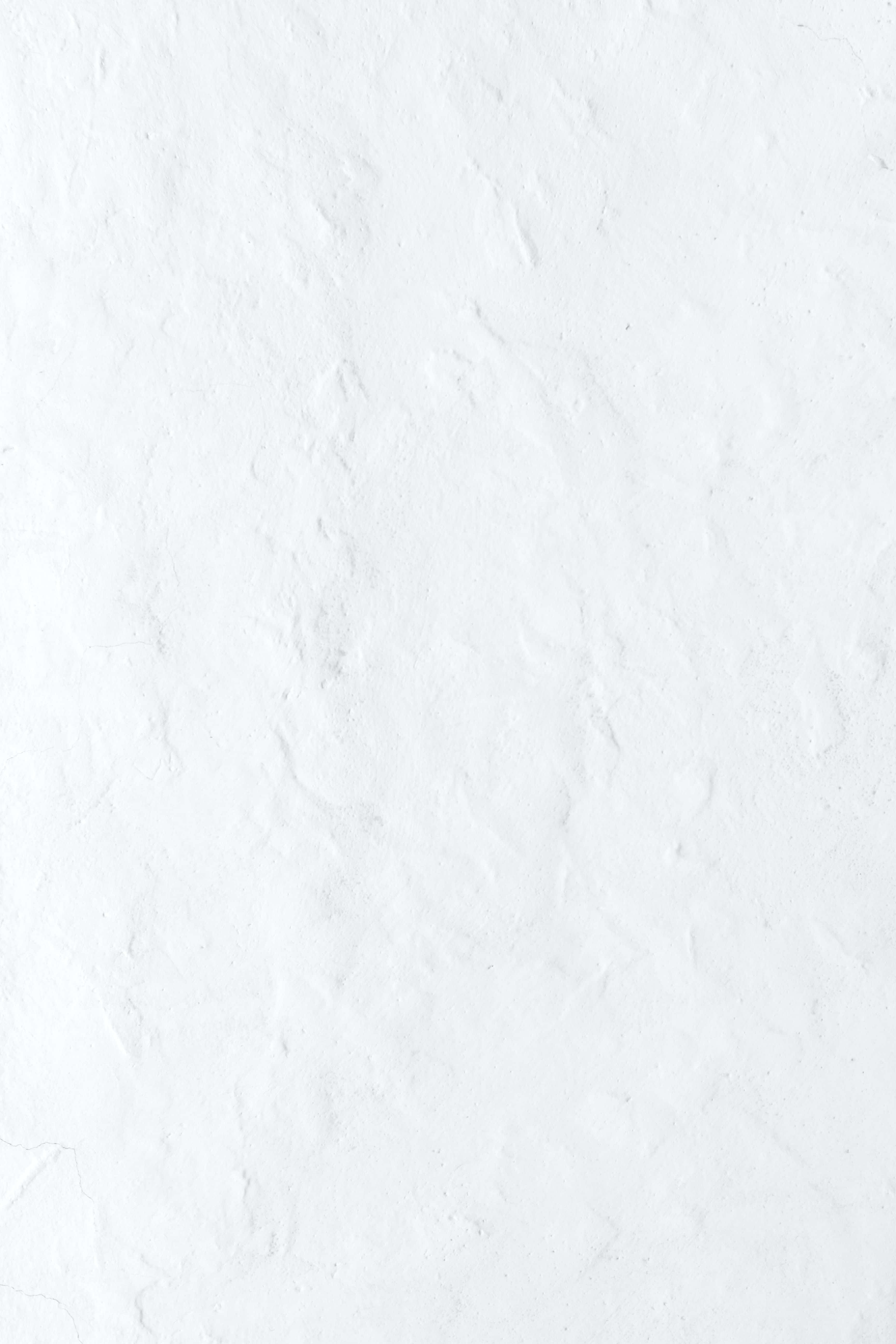 Solid White 桌布 壁紙 — 光滑白色紋理牆壁的特寫，帶有微妙的凹凸表面細節。