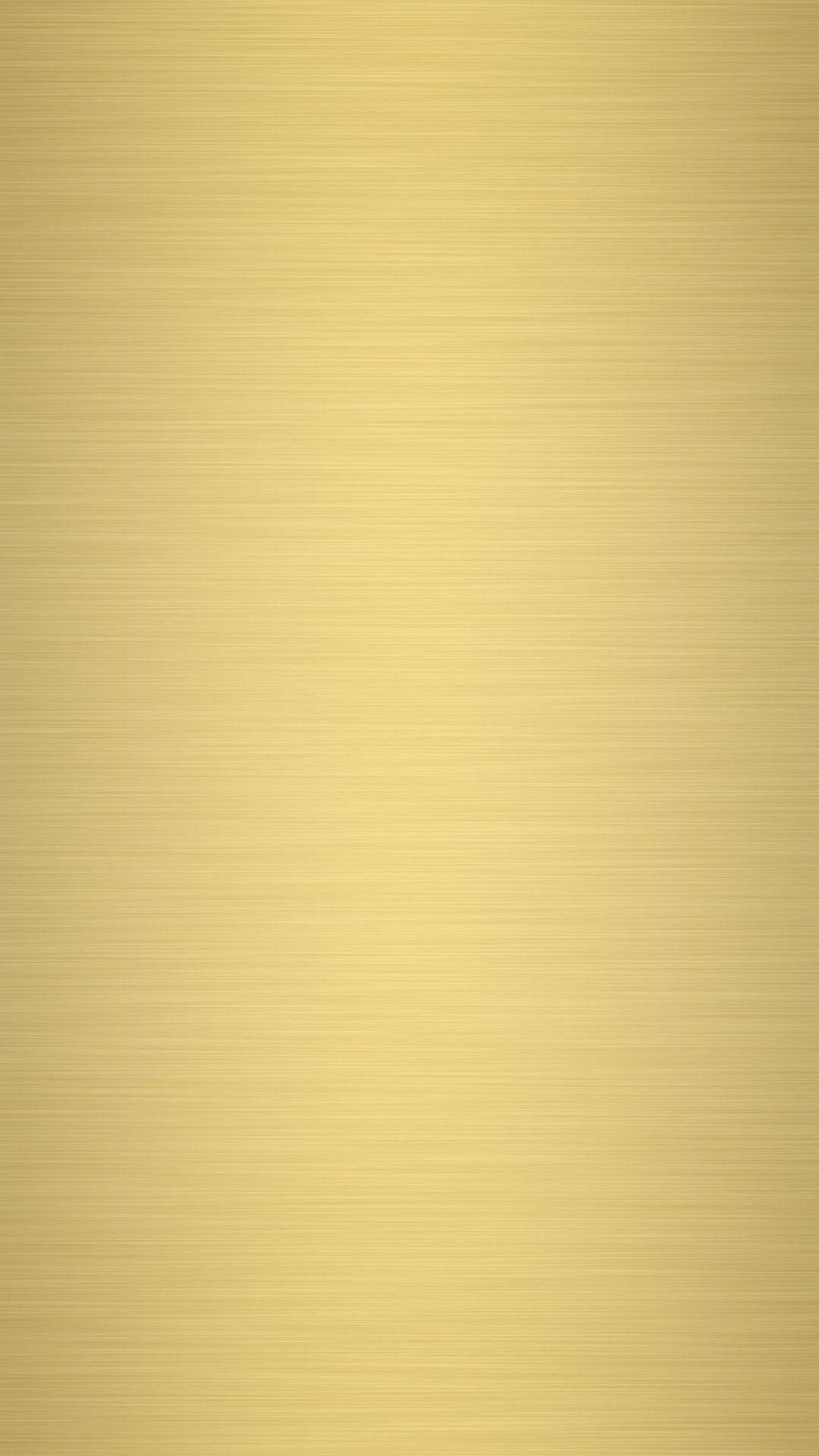 Gold Abstract 桌布 壁紙 — 光滑金色表面帶有細膩水平拉絲紋理，反射柔和環境光。