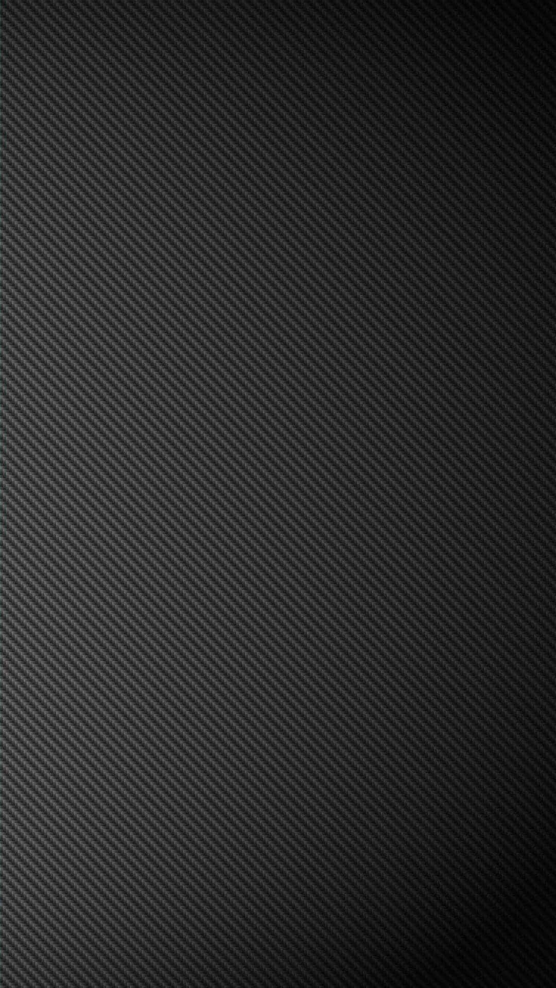 Dark Grey 桌布 壁紙 — 光滑黑色碳纖維紋理，帶有斜紋編織圖案和微妙的漸變照明。