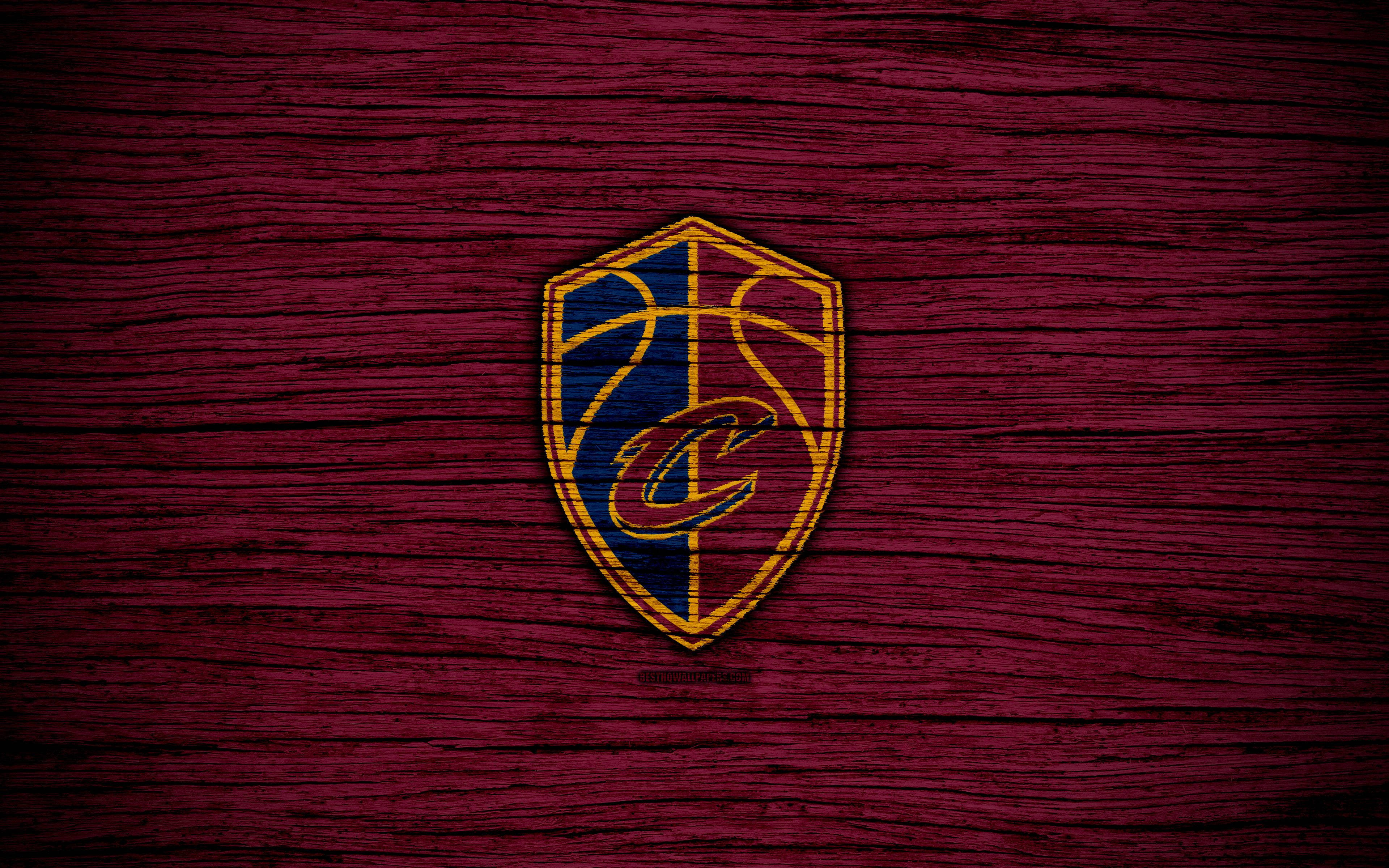 cavaliers 桌布 壁紙 — 克里夫蘭騎士隊標誌居中放置在帶有紋理細節的深酒紅色木紋背景上。