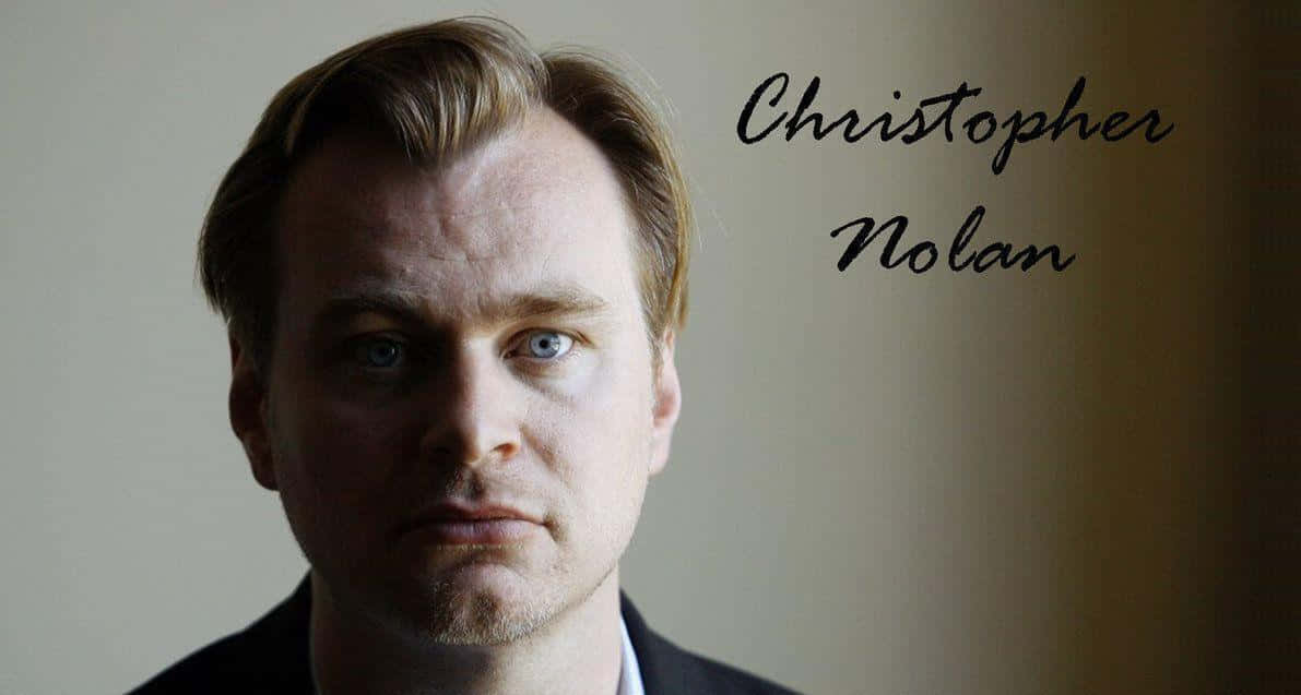 Christopher Nolan 桌布 壁紙 — 克里斯多福·諾蘭的 close-up 肖像，藍色眼睛深邃，表情嚴肅，背景柔和模糊。