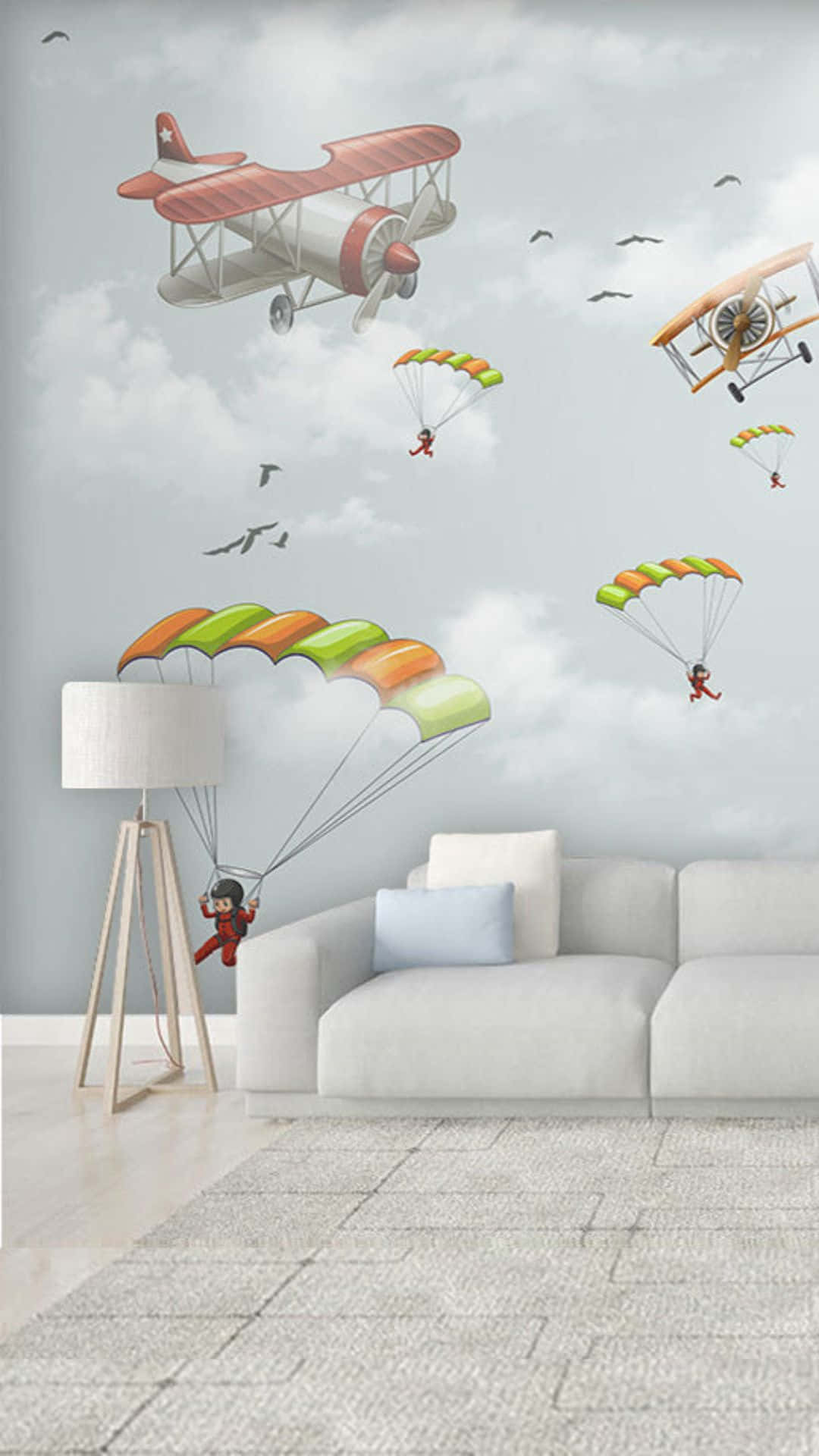Android Small Planes 桌布 壁紙 — 兒童房內有充滿奇思妙想的壁紙，上面有復古雙翼飛機和色彩繽紛的降落傘在雲層密布的天空中飛翔。