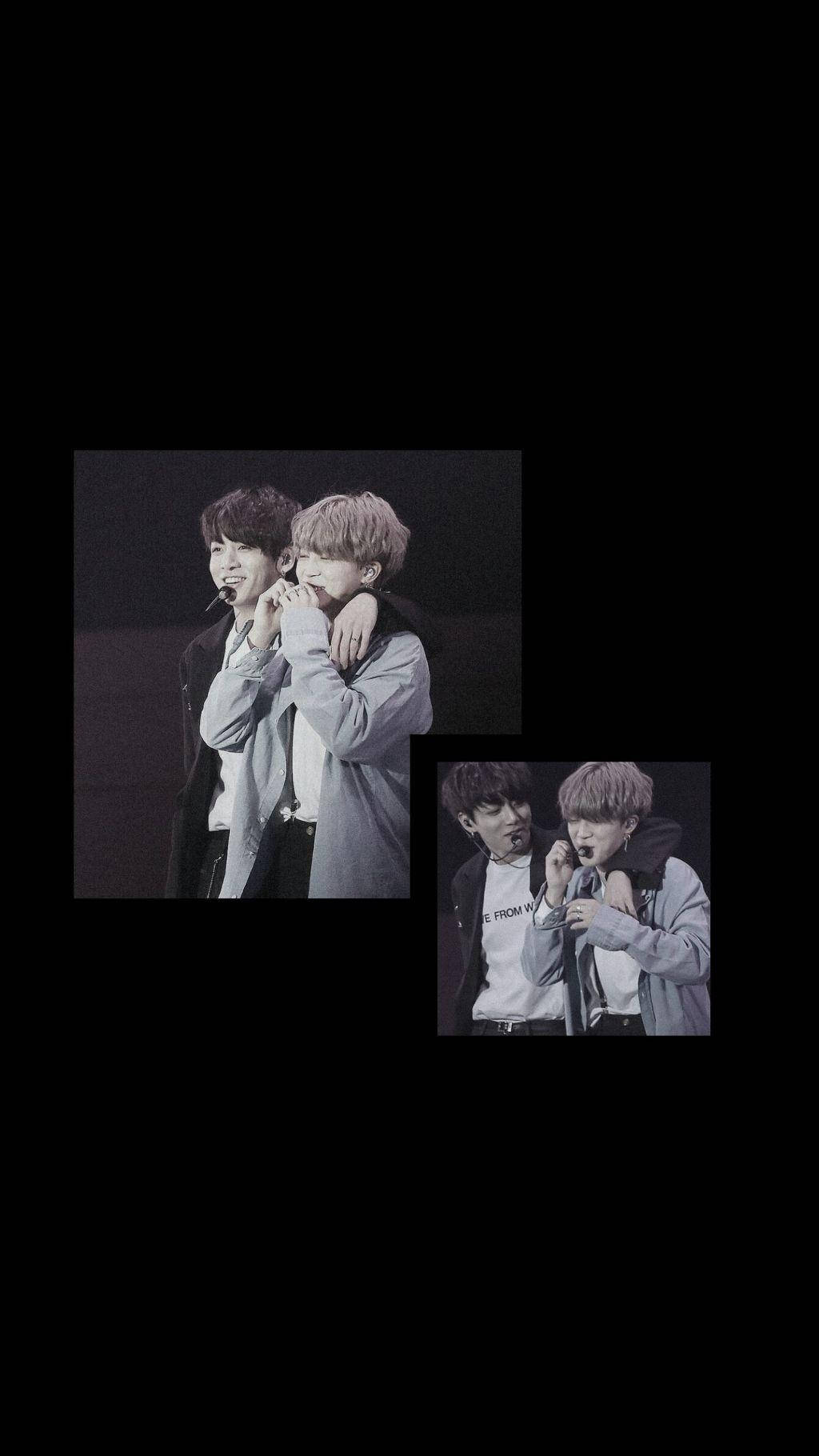 BTS 黑色 桌布 壁紙 — 兩位年輕男子在昏暗燈光下、黑色背景的舞台上熱情擁抱。