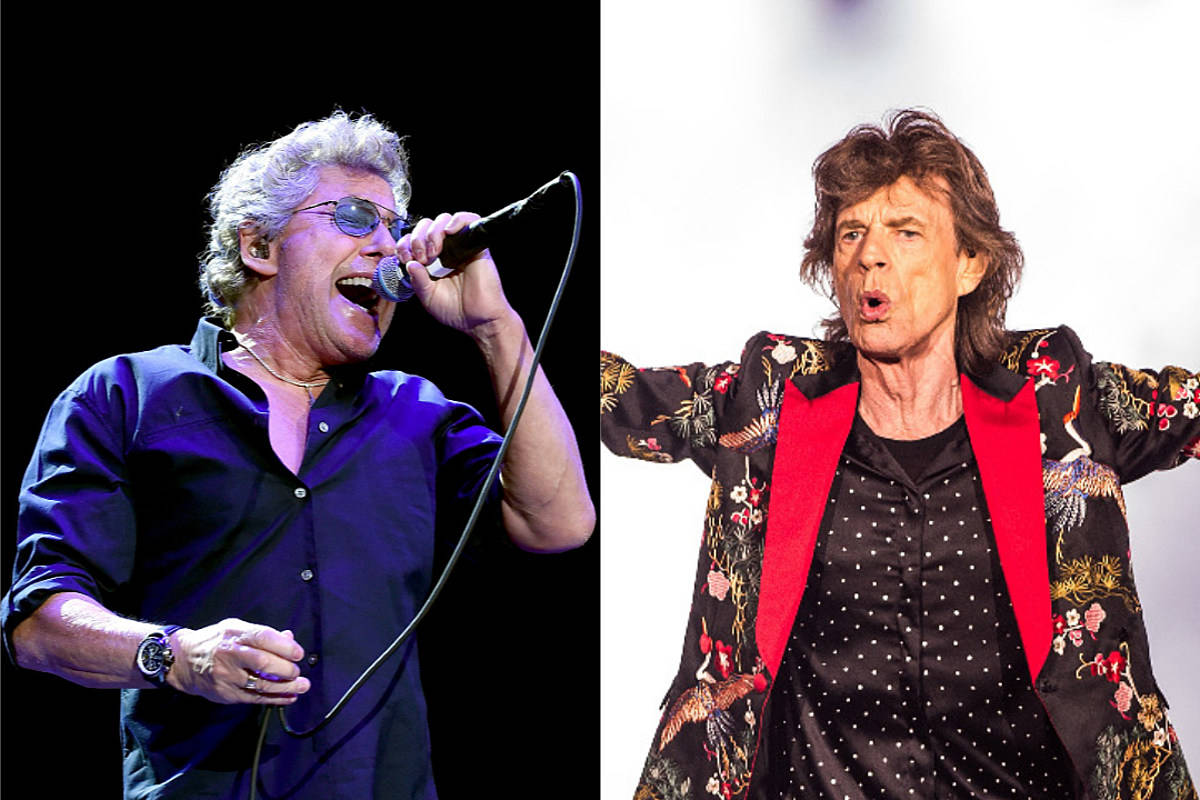 Rock 桌布 壁紙 — 兩位搖滾音樂家在舞台上熱情演出，一位身穿深色襯衫和太陽眼鏡，另一位身穿帶紅色翻領的花卉外套。