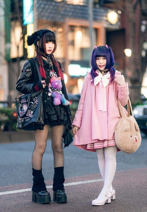 兩位身穿粉色服裝的女孩站在街頭 壁紙
