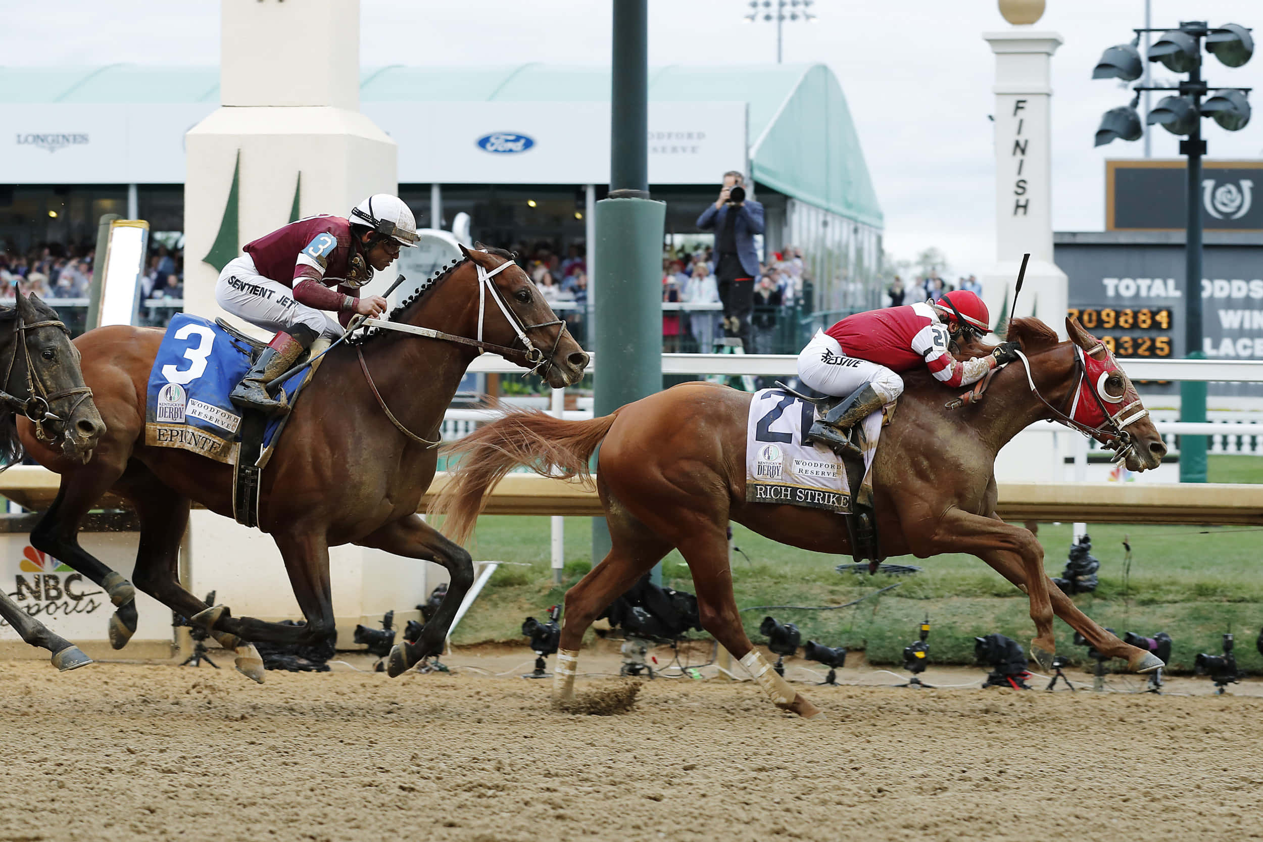Kentucky Derby 桌布 壁紙 — 兩位騎師在激烈賽馬中，與他們的純種馬並駕齊驅衝向終點線。