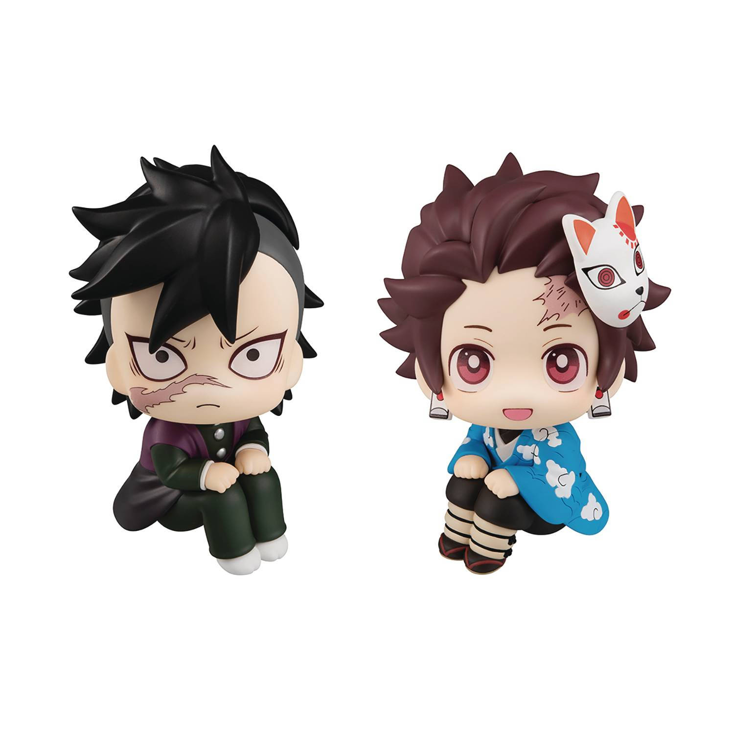 genya 桌布 壁紙 — 兩個來自《鬼滅之刃》的Q版動漫人偶並排而坐，一個黑髮怒容，另一個棕髮戴狐面具，笑容燦爛。