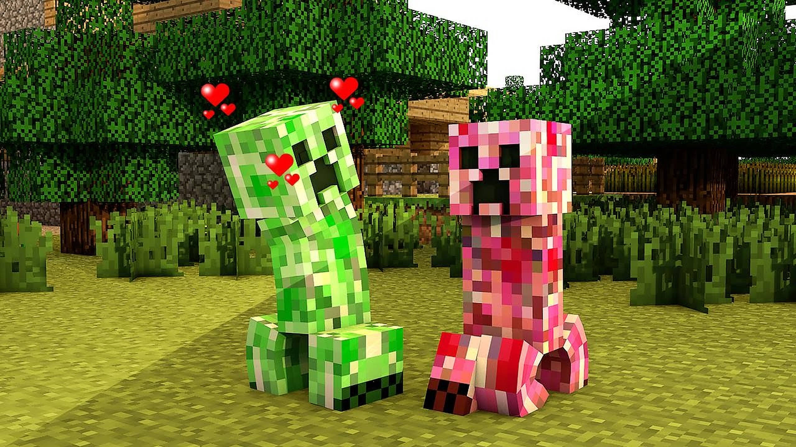 Creeper 桌布 壁紙 — 兩個像素化的 Minecraft 苦力怕和一個粉紅色苦力怕一起坐在長滿草的森林裡，上面有漂浮的心形。