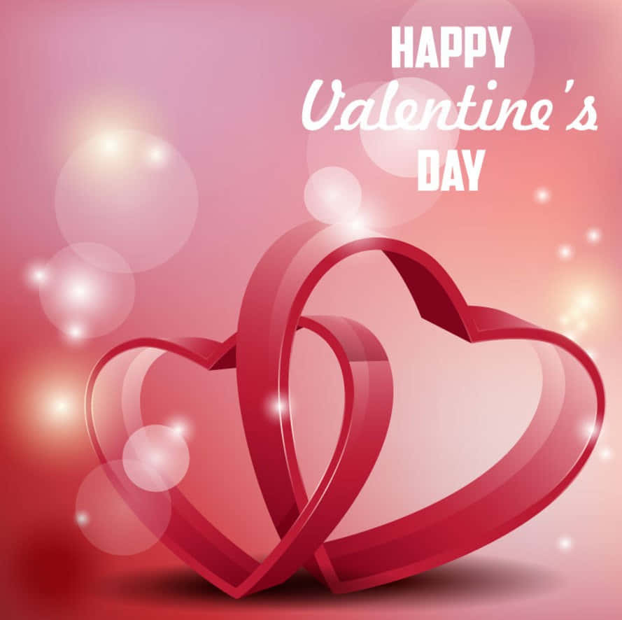 valentine 桌布 壁紙 — 兩個光滑的紅色交織心形在柔和的粉紅色散景背景上發光，並帶有「Happy Valentine's Day」文字。