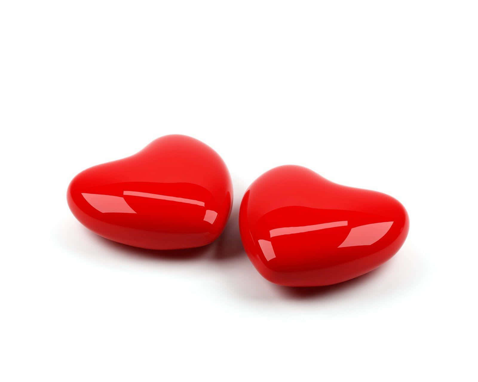 Cute Love Heart 桌布 壁紙 — 兩個光澤的紅色心形物體放在純白色背景上，下方有柔和的陰影。