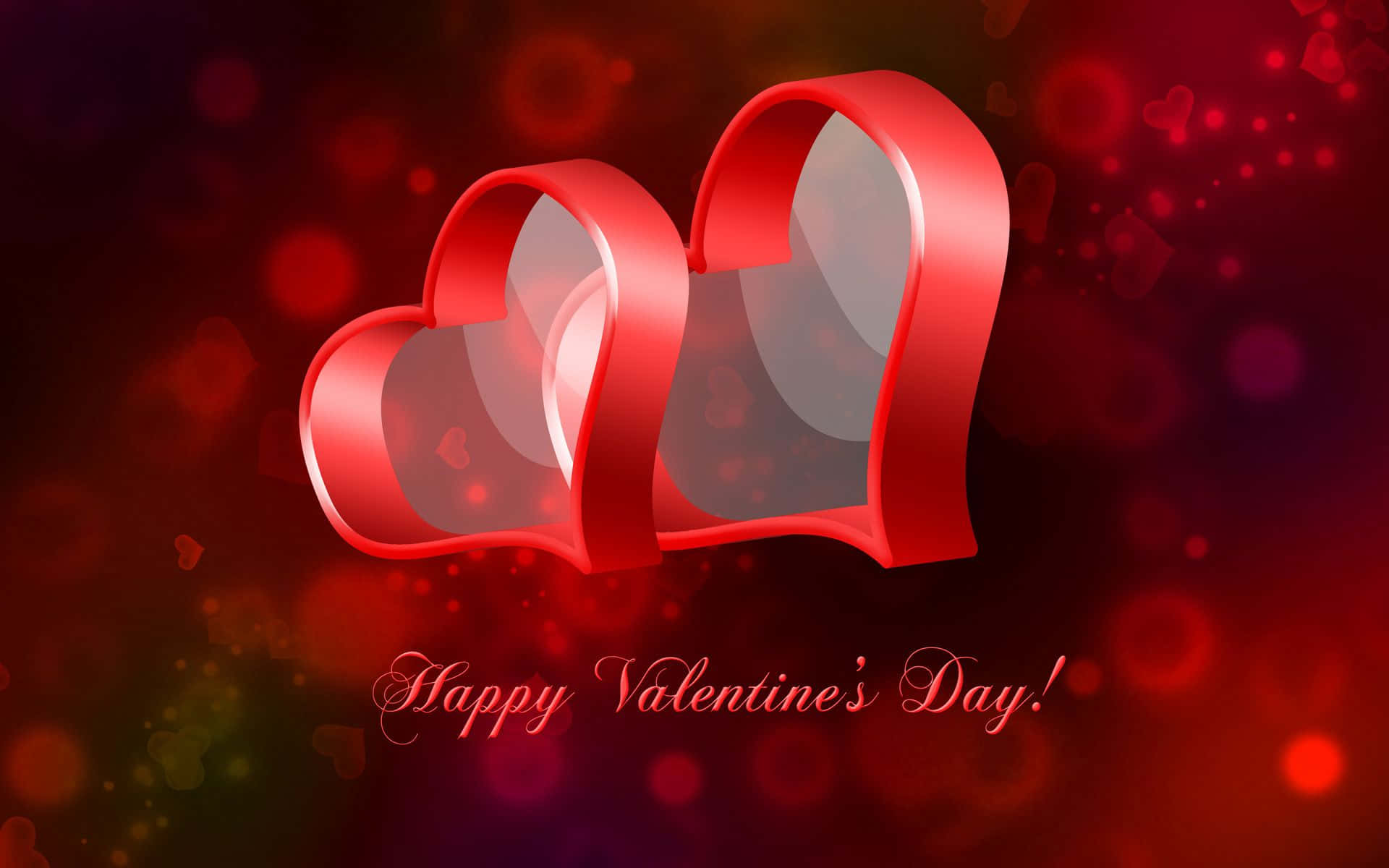 Valentines 桌布 壁紙 — 兩個光澤的紅色絲帶心形漂浮在模糊的散景背景上，帶有漂浮的心形粒子和草書情人節訊息。