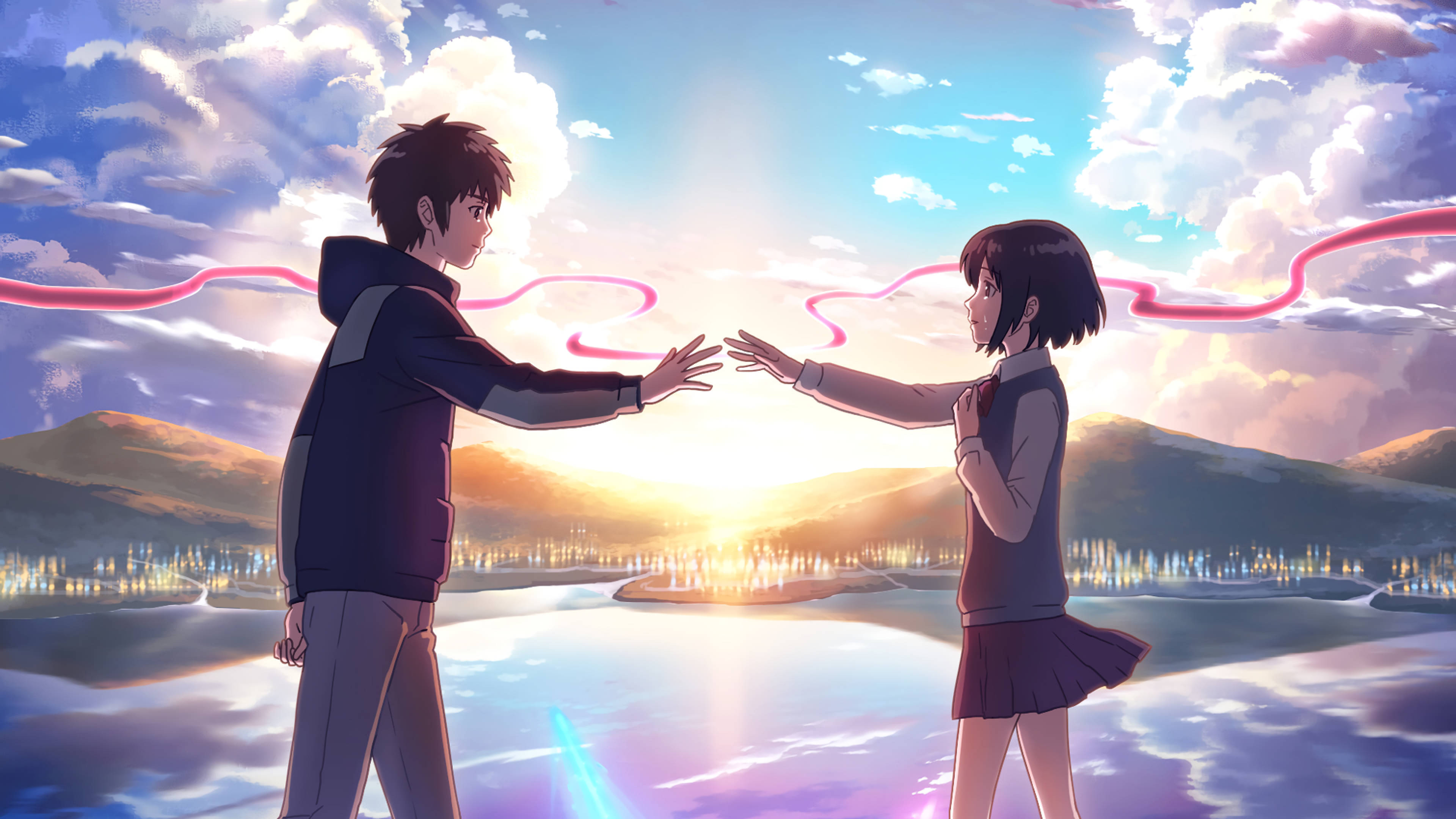 Your Name 桌布 壁紙 — 兩個動漫青少年在日落時分穿過發光的湖面伸手觸碰對方，粉紅色能量絲帶在上空盤旋。