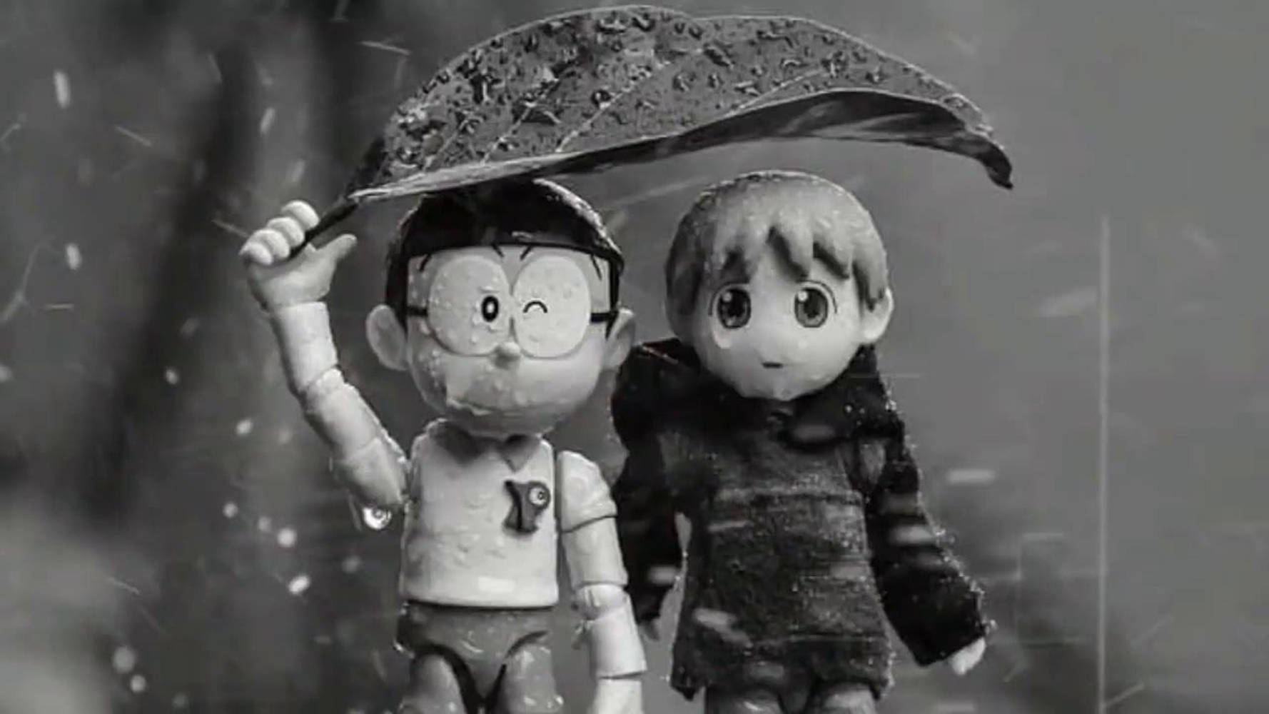 Animated 桌布 壁紙 — 兩個動漫風格公仔在單色暴雨中共享一片樹葉當傘。