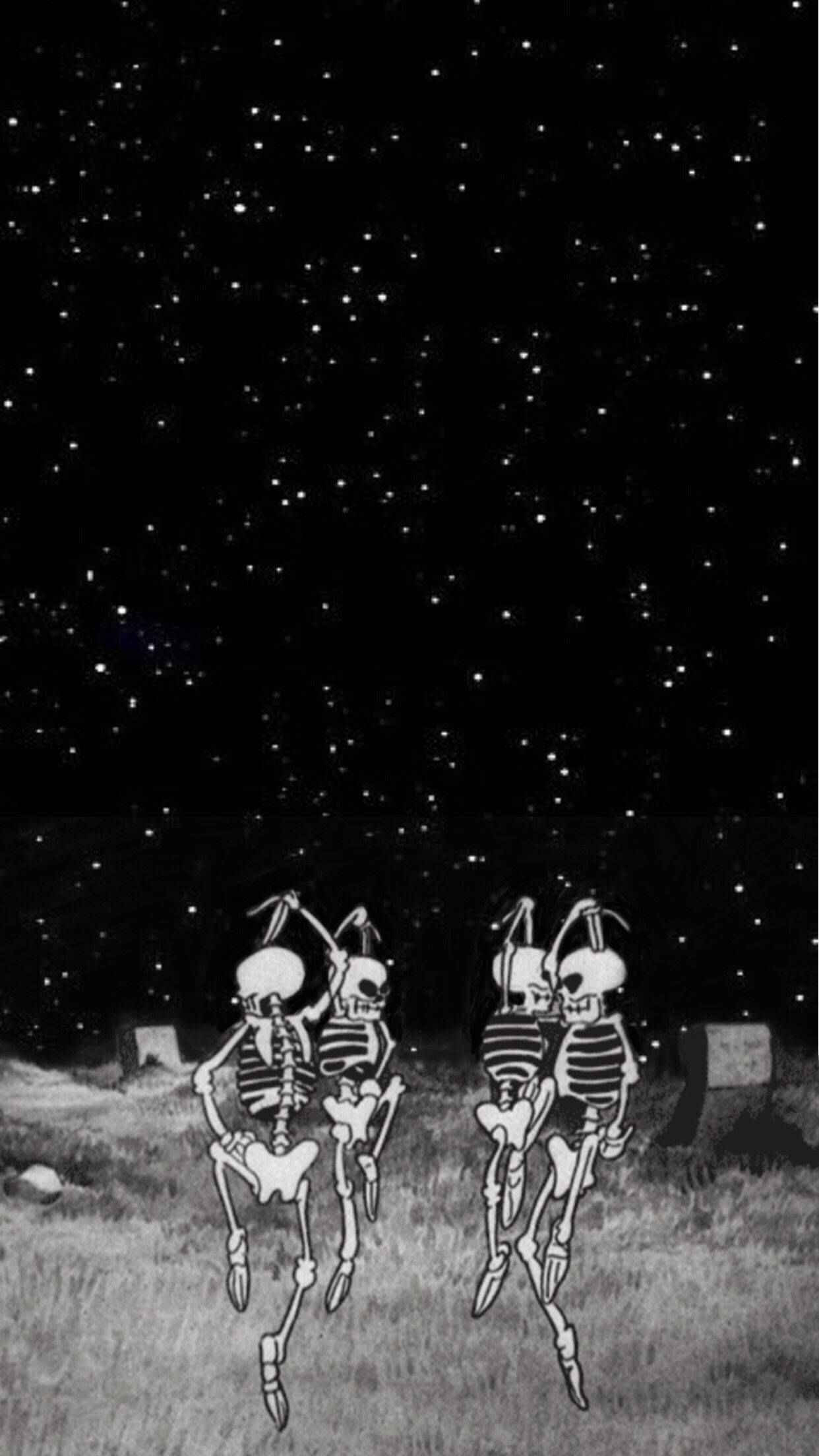 桌布 壁紙 — 兩個卡通骷髏在星空下的墓園裡快樂地跳舞。