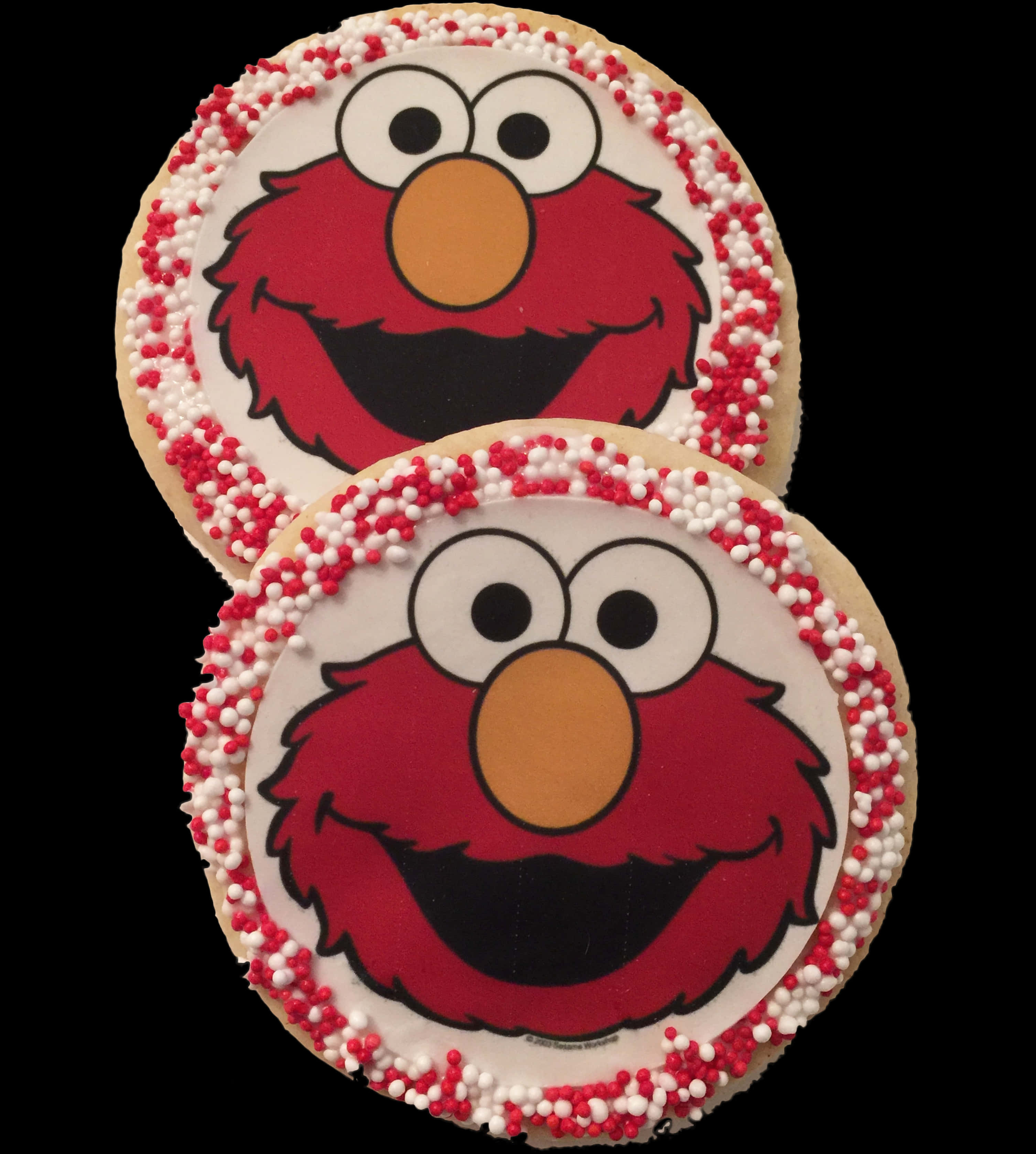 Elmo 桌布 壁紙 — 兩個圓形餅乾，裝飾有 Elmo 的臉和紅白灑糖，背景為黑色。