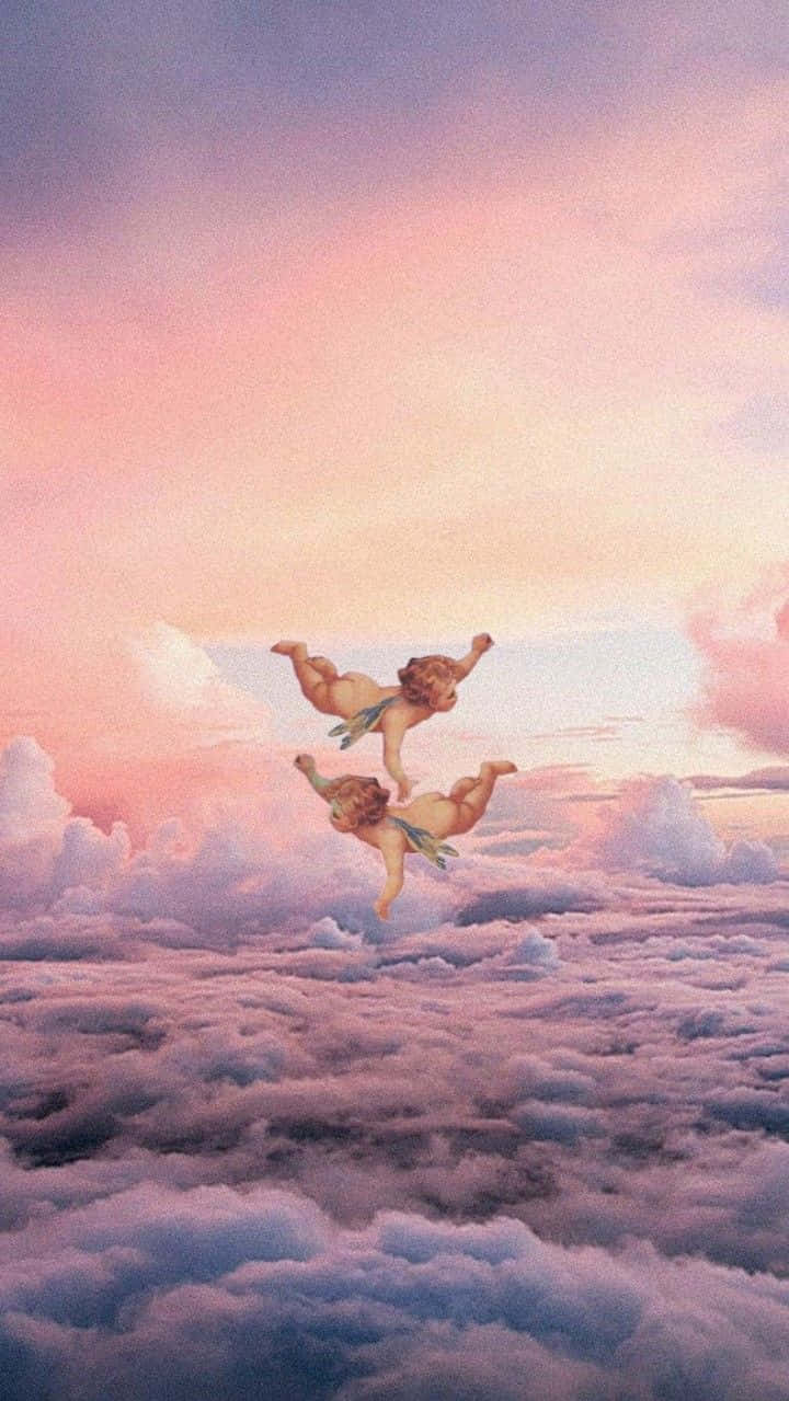 Angel Aesthetic Clouds 桌布 壁紙 — 兩個小天使在夢幻的粉紅和紫色天空下，優雅地翱翔於一片粉彩雲海之上。