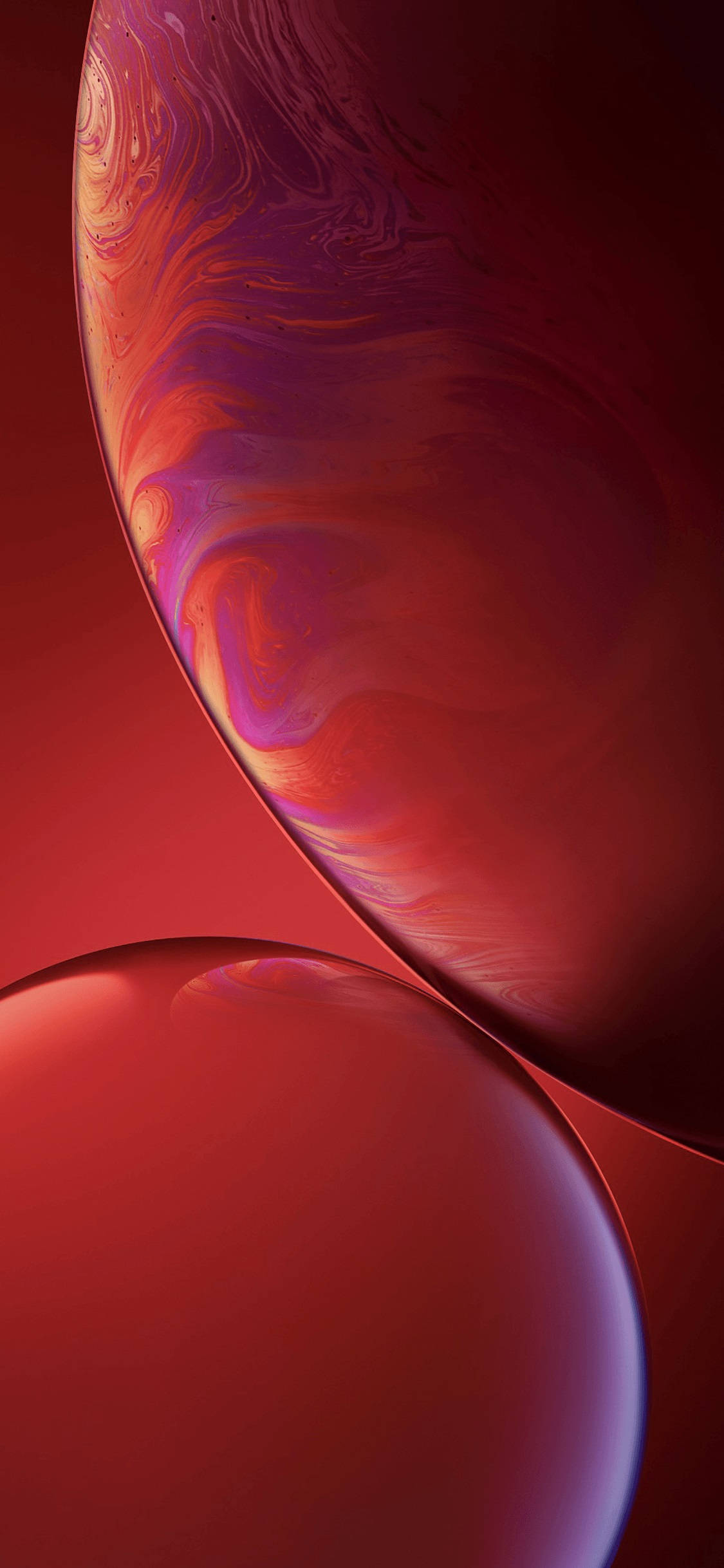 紅色 iPhone 桌布 壁紙 — 兩個帶有旋轉紅、紫、橙漸層的光澤球體，漂浮在深紅色背景上。