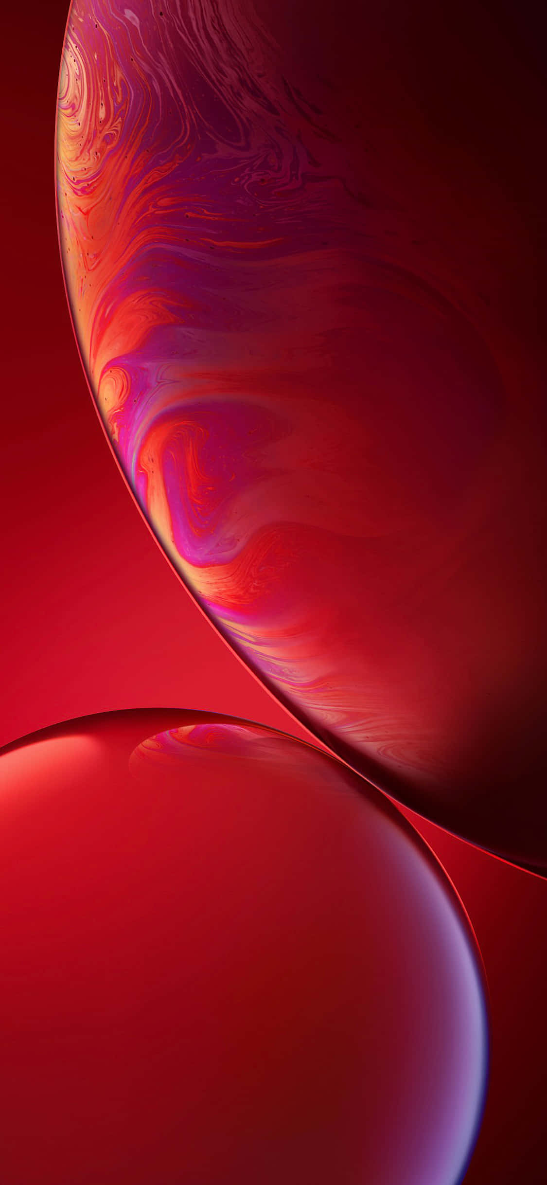 iPhone 11 桌布 壁紙 — 兩個帶有旋轉紅、紫、橙色調的光澤球體漂浮在深紅色漸變背景上。