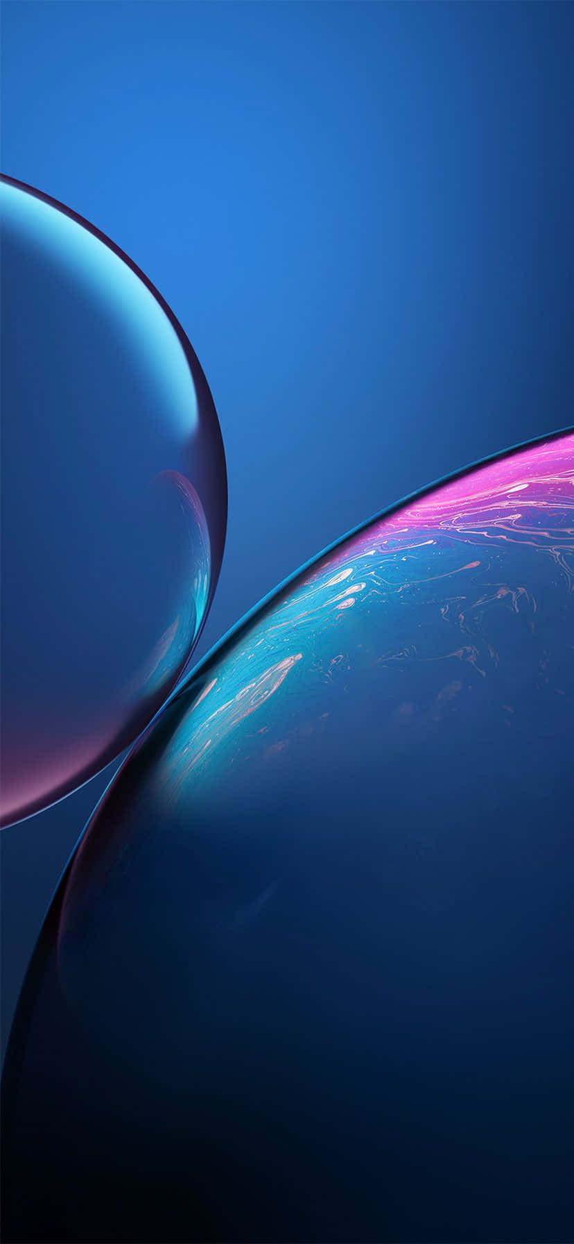 iPhone 鎖定畫面 桌布 壁紙 — 兩個帶有虹彩藍色和粉紅色調的光澤球體漂浮在深藍色漸變背景上。