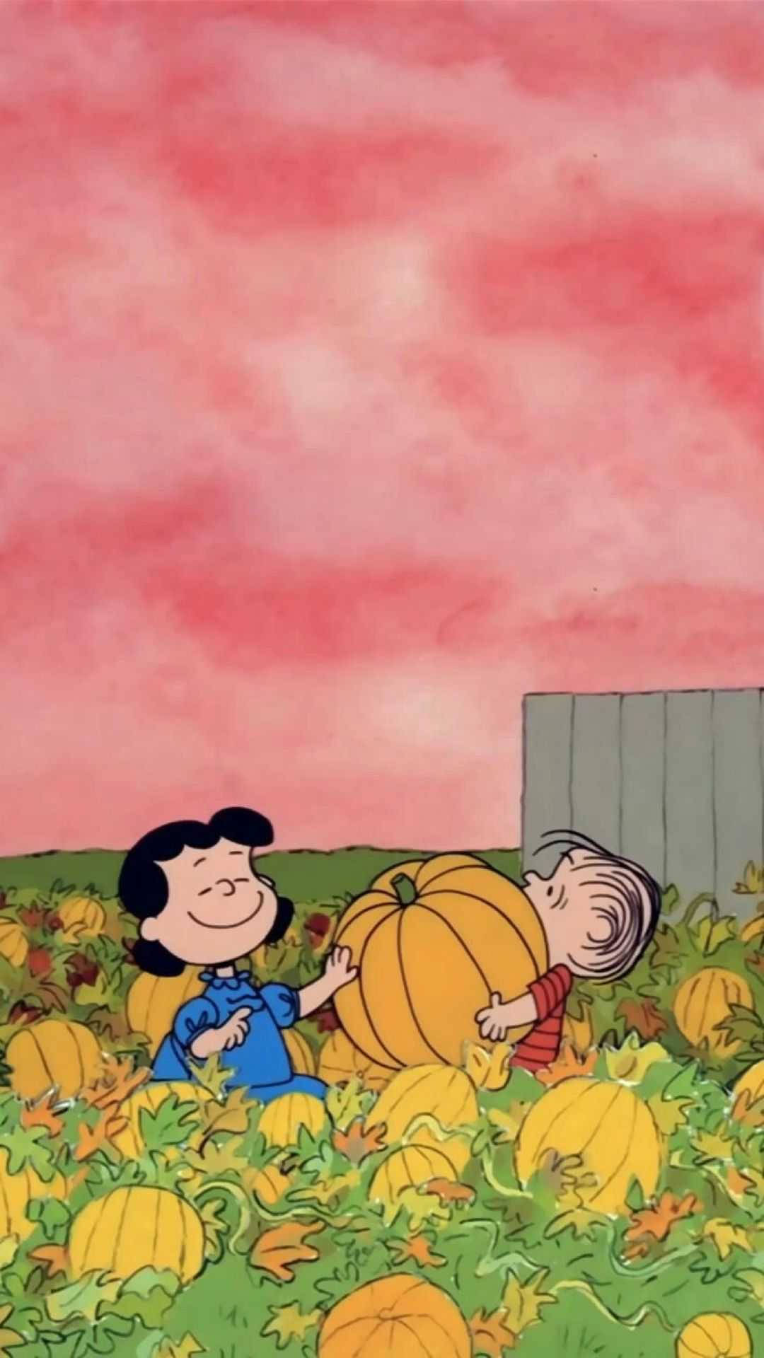 lucy 桌布 壁紙 — 兩個微笑的卡通小孩在粉紅色天空下，在充滿活力的秋田裡快樂地擁抱一個巨大的南瓜。