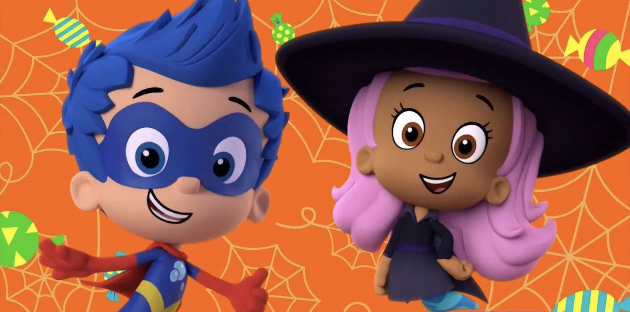 Bubble Guppies 桌布 壁紙 — 兩個快樂的卡通小孩打扮成超級英雄和女巫，在充滿活力的橙色蜘蛛網背景下慶祝萬聖節。