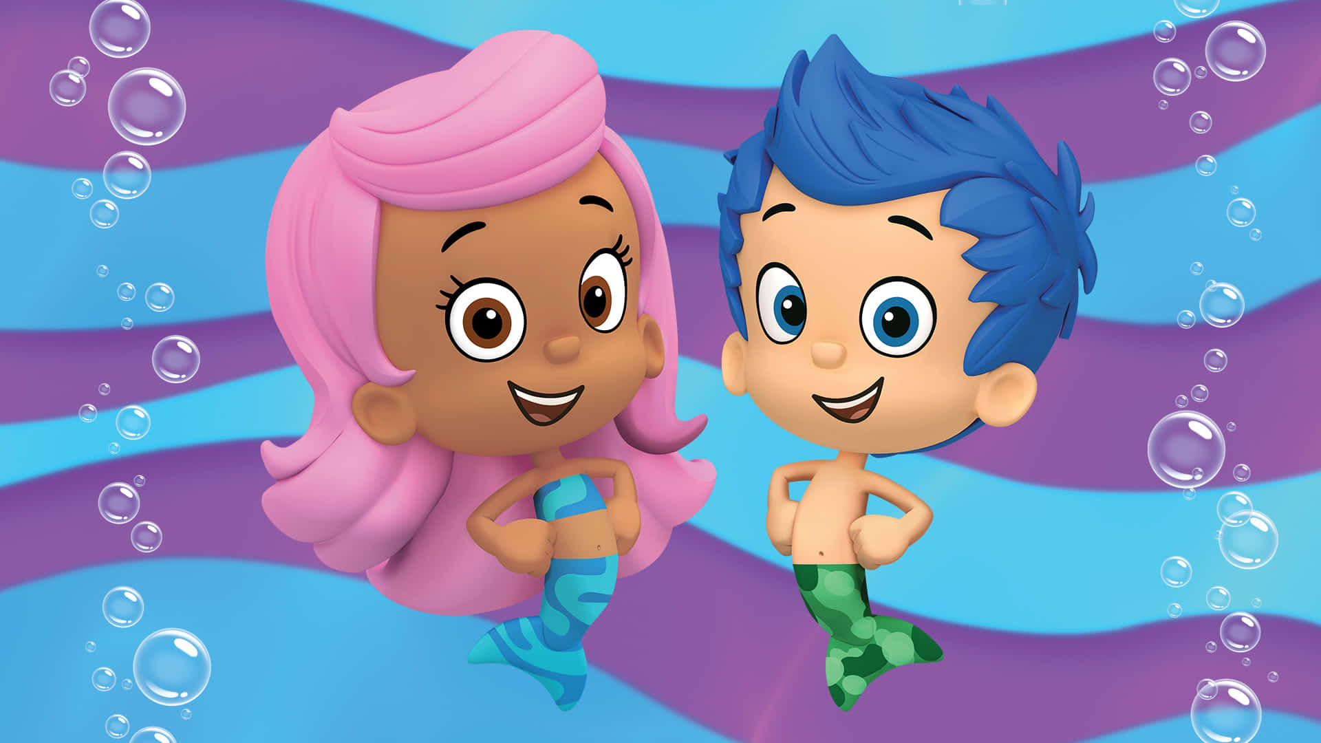 Bubble Guppies 桌布 壁紙 — 兩個快樂的卡通美人魚小孩，有粉紅色和藍色的頭髮，在波浪狀的紫色和藍色背景上，在浮動的泡泡中快樂地游泳。