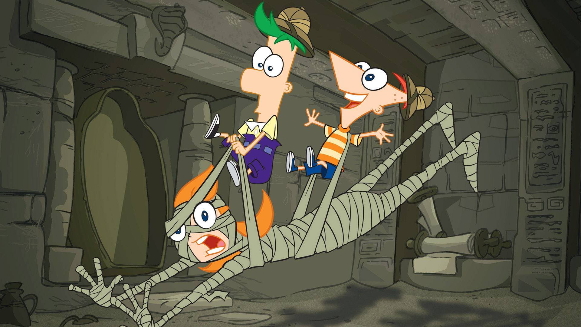 Ferb 桌布 壁紙 — 兩個戴著探險家帽子的卡通男孩，快樂地騎著木乃伊穿過一個充滿古代文物的石墓。