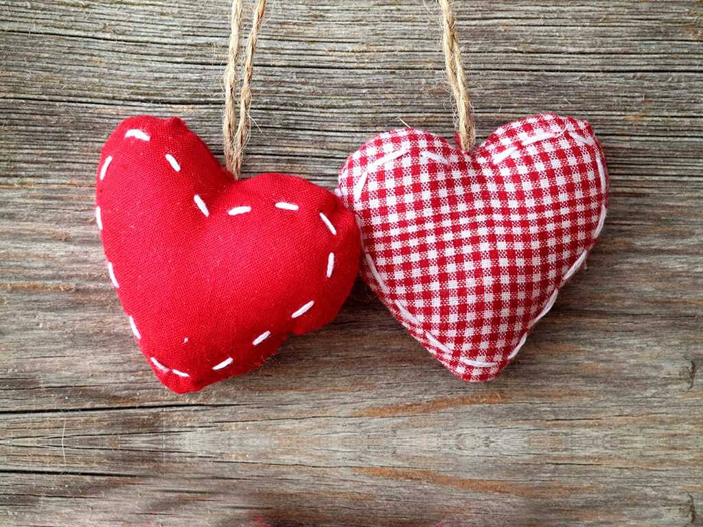 Love Heart 桌布 壁紙 — 兩個手工布藝心形，一個純紅色配白色縫線，另一個紅白格紋，用麻繩掛在風化木上。