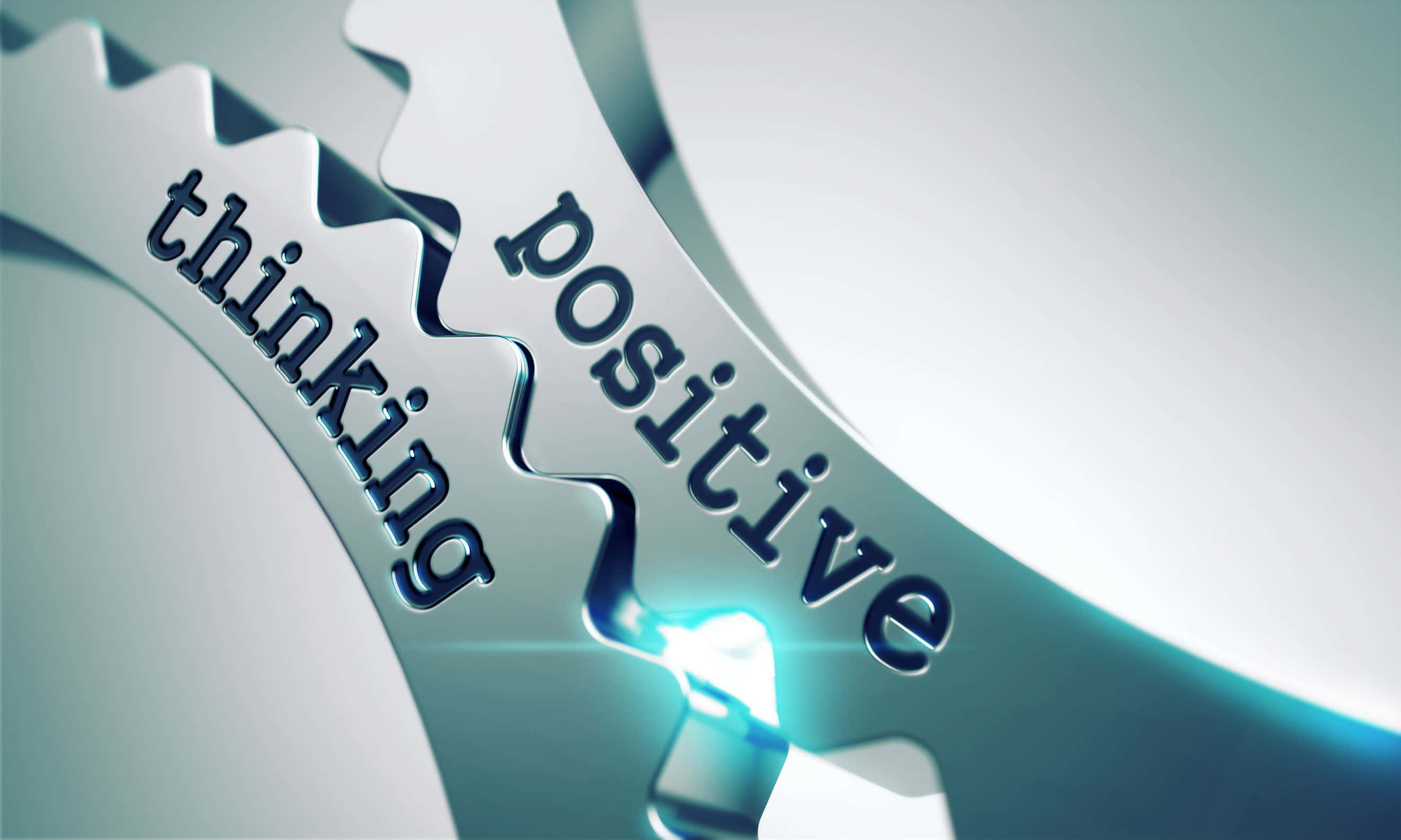 Positive 桌布 壁紙 — 兩個標有 thinking 和 positive 的金屬齒輪在連接點處相互嚙合，並發出藍色光芒。