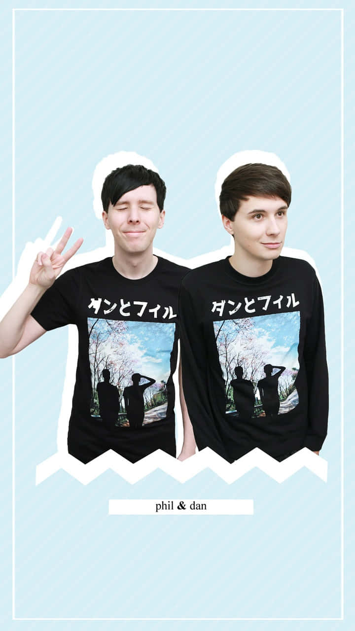 dan and phil 桌布 壁紙 — 兩個男人穿著印有櫻花圖案的黑色T恤，在淺藍色背景前開心地擺姿勢。