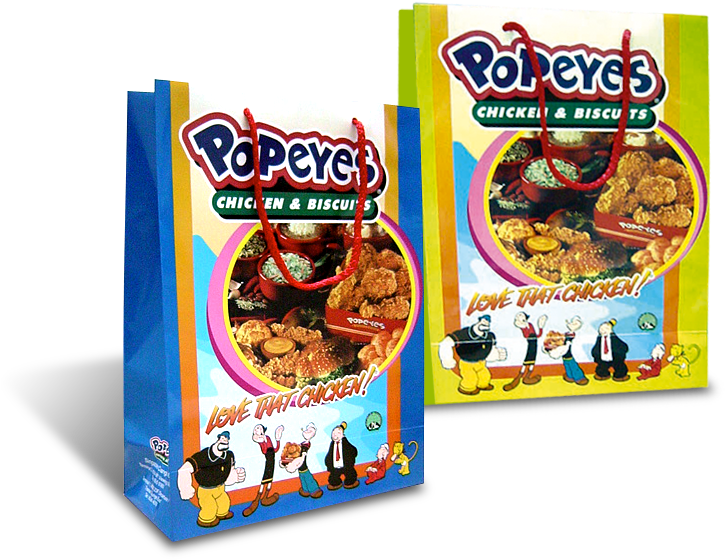 大力水手 桌布 壁紙 — 兩個色彩繽紛的Popeyes雞肉和餅乾紙袋，上面有卡通人物和炸雞圖案。