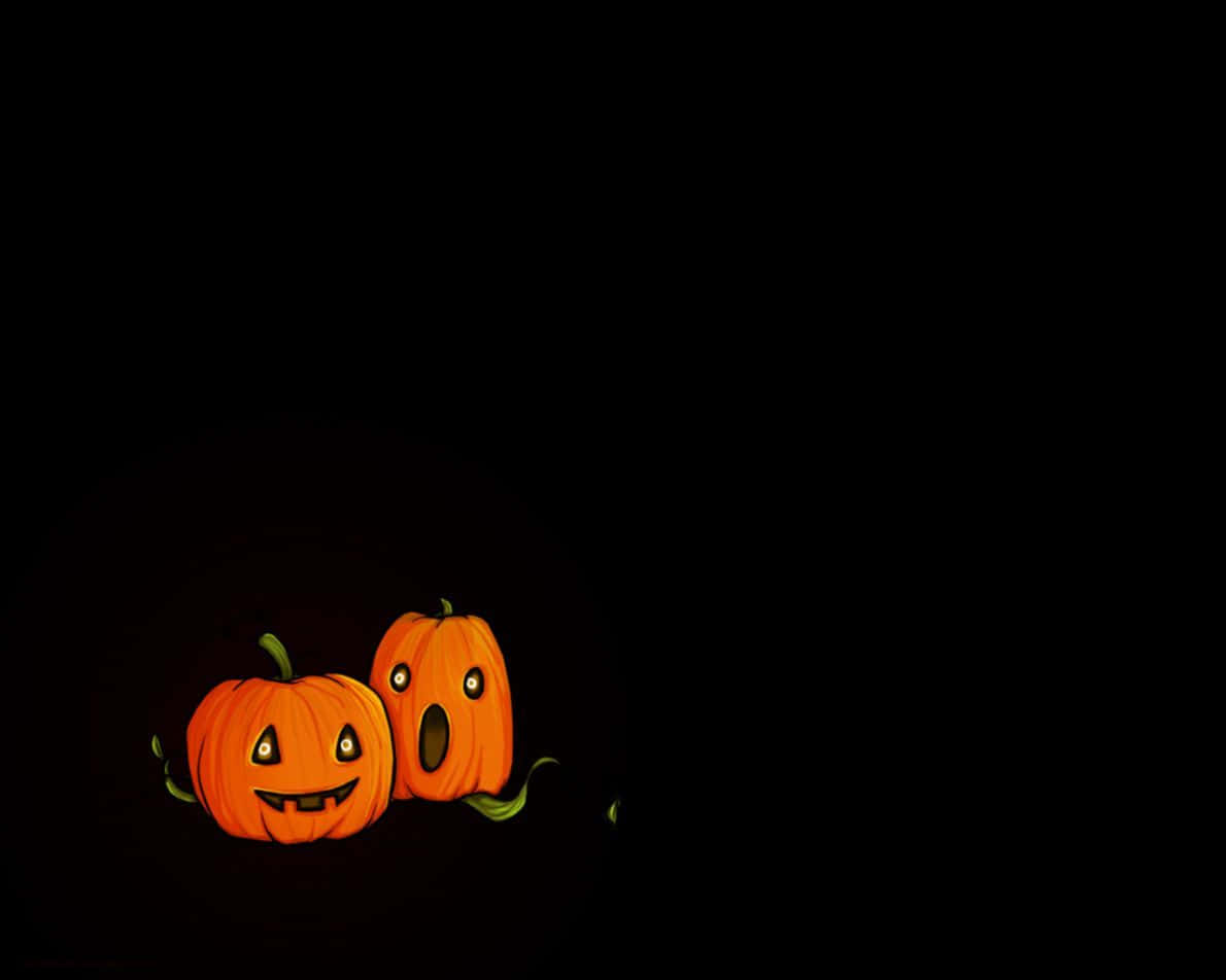 Animated 桌布 壁紙 — 兩個表情豐富的發光傑克南瓜燈在漆黑的背景下閃閃發光。